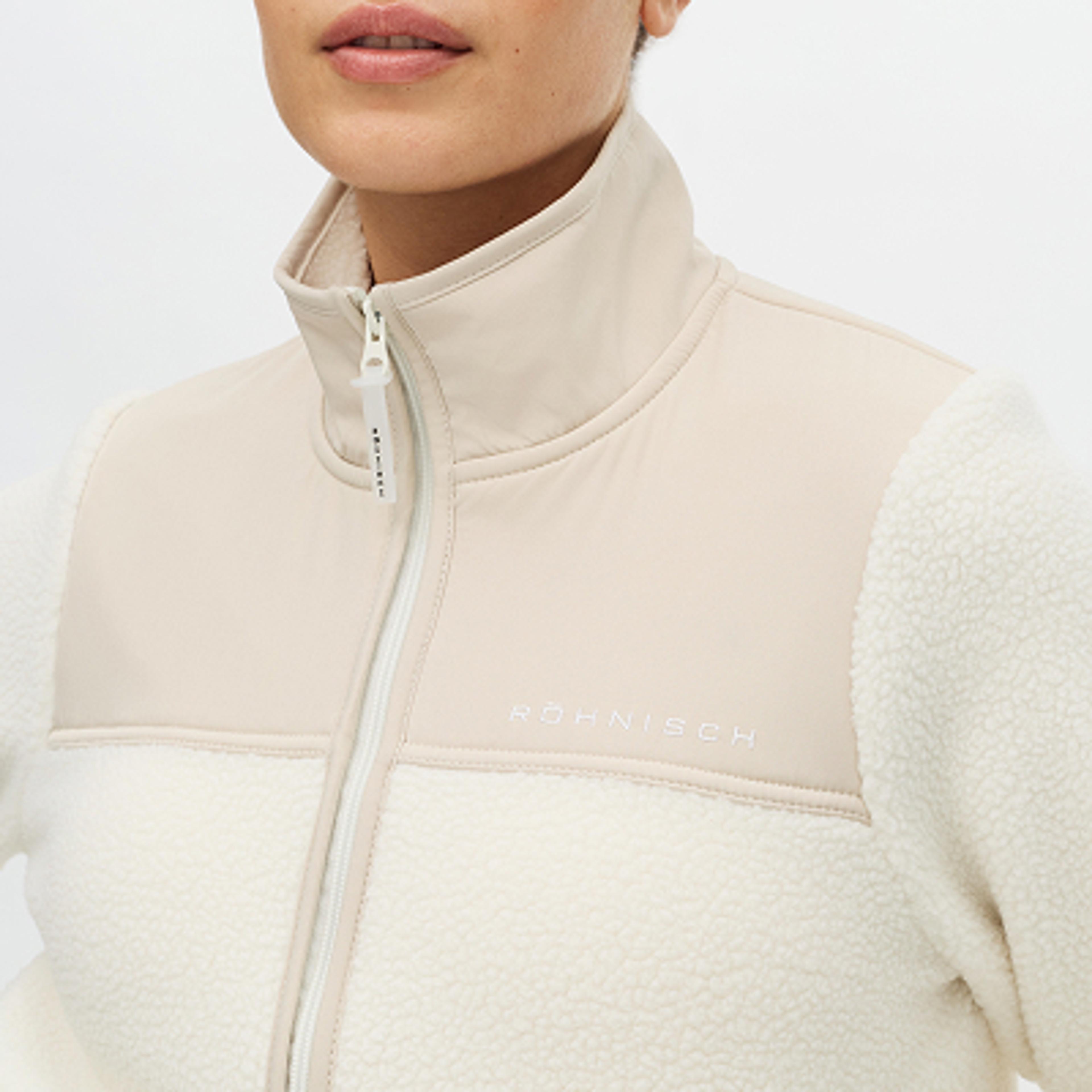 Two-tone RÖHNISCH jacket with off-white fleece and beige smooth fabric panels, featuring a zipper.