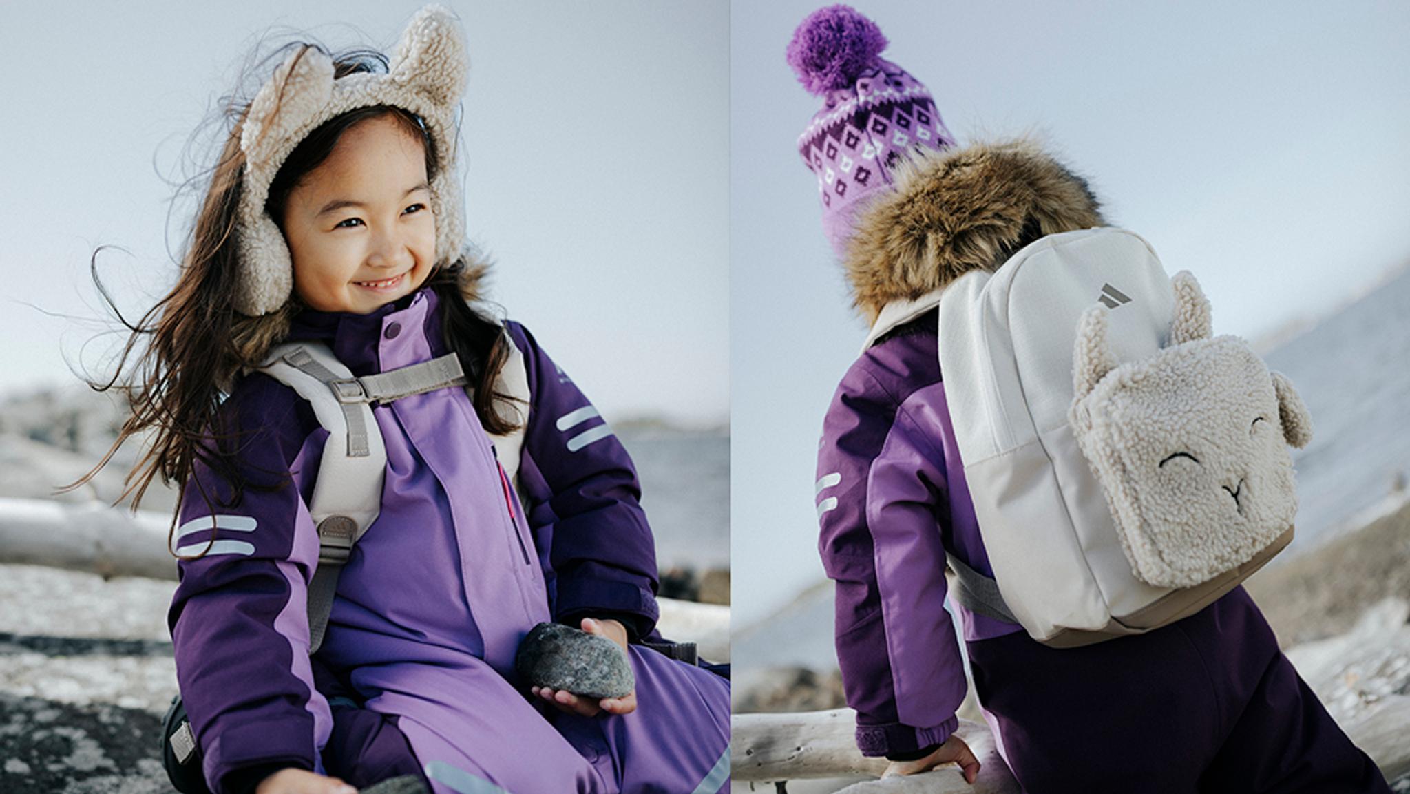 Smiling child in a purple snowsuit and fuzzy earmuffs (left), and from behind with a purple hat and sheep-themed backpack (right).