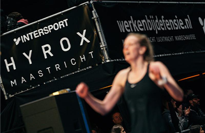 a woman is boxing in front of a large sign .