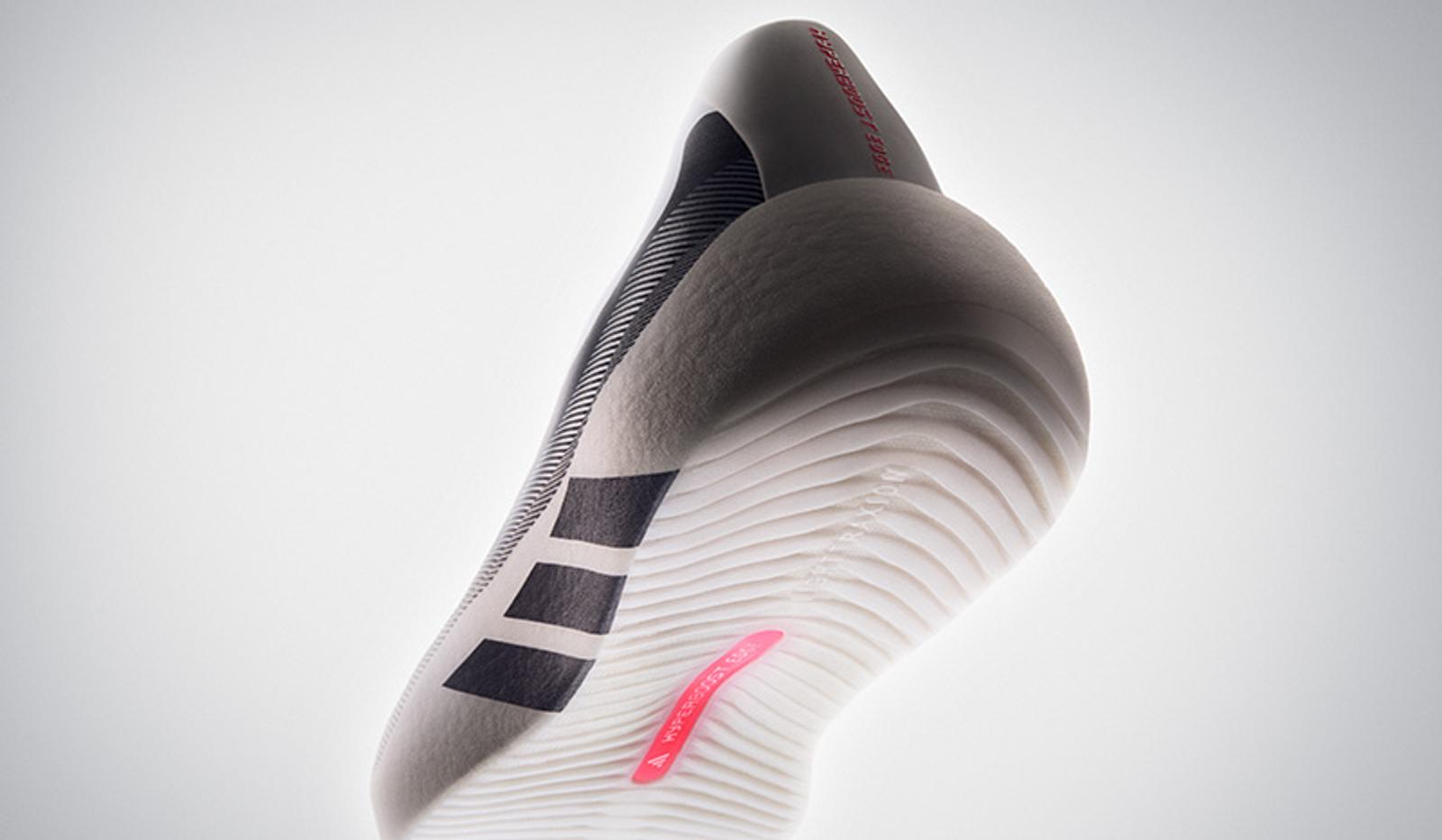 Adidas athletic shoe, grey and white with black stripes, textured white sole, and pink accent.
