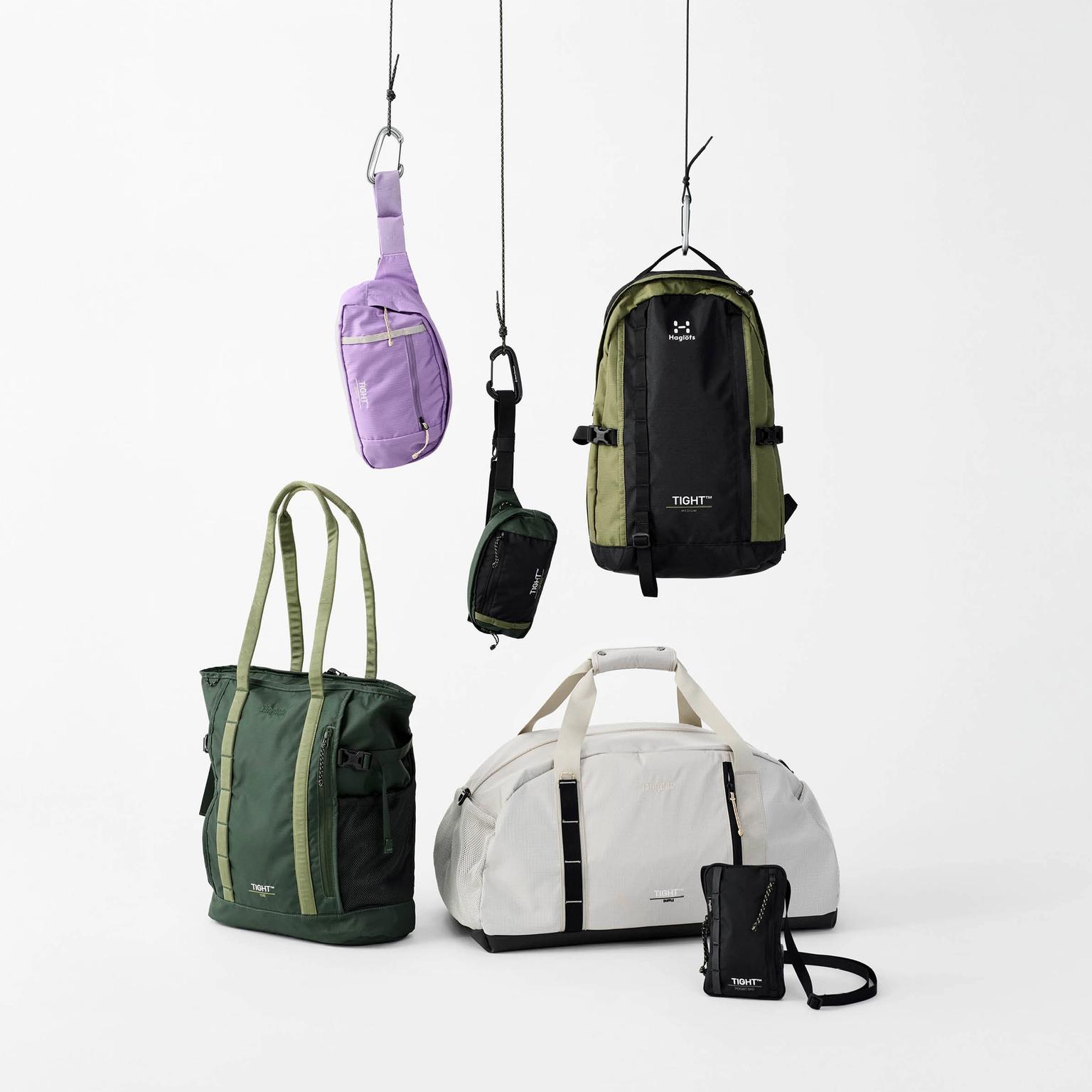 a group of bags hanging from hooks on a white background .