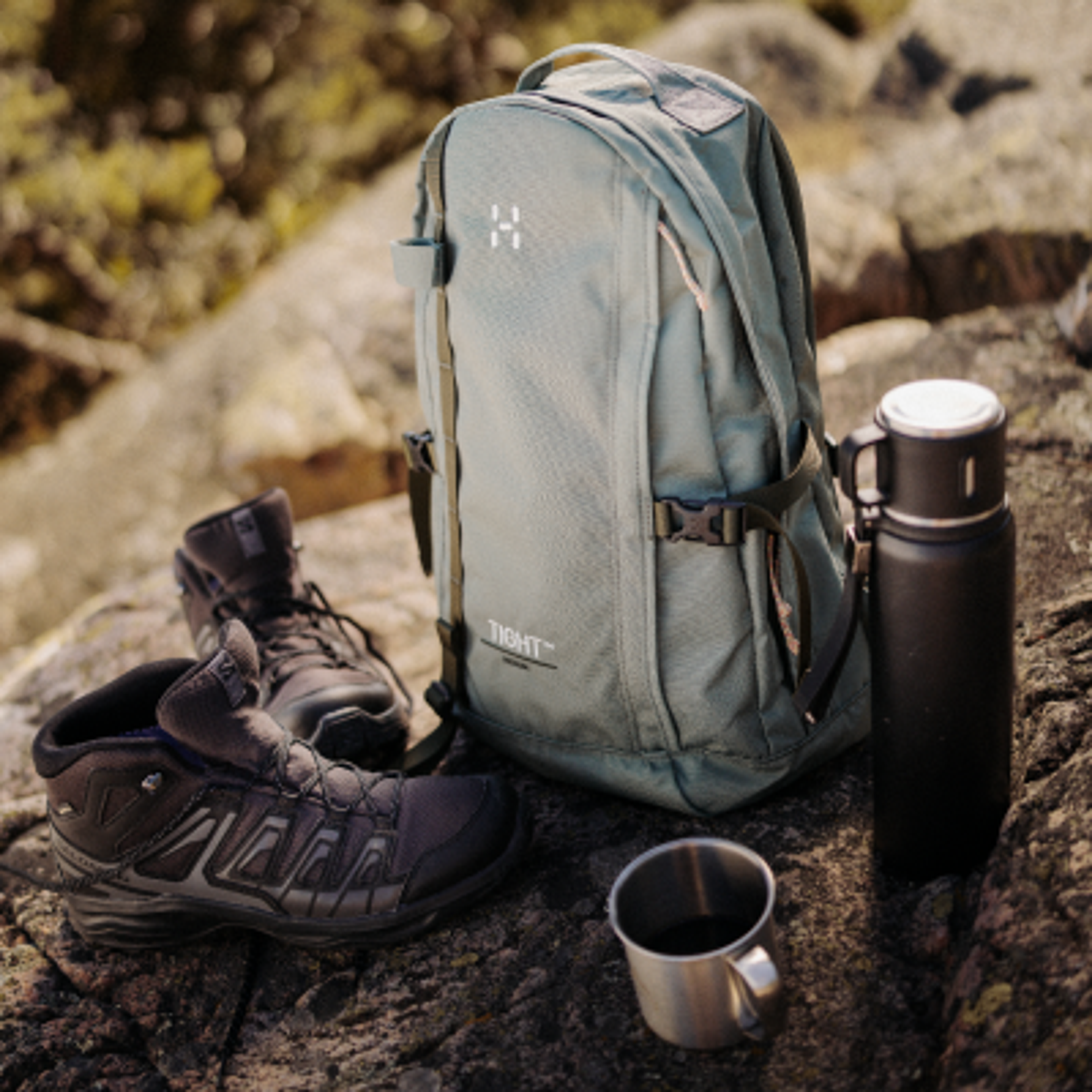 a person is pouring coffee into a stainless steel mug .