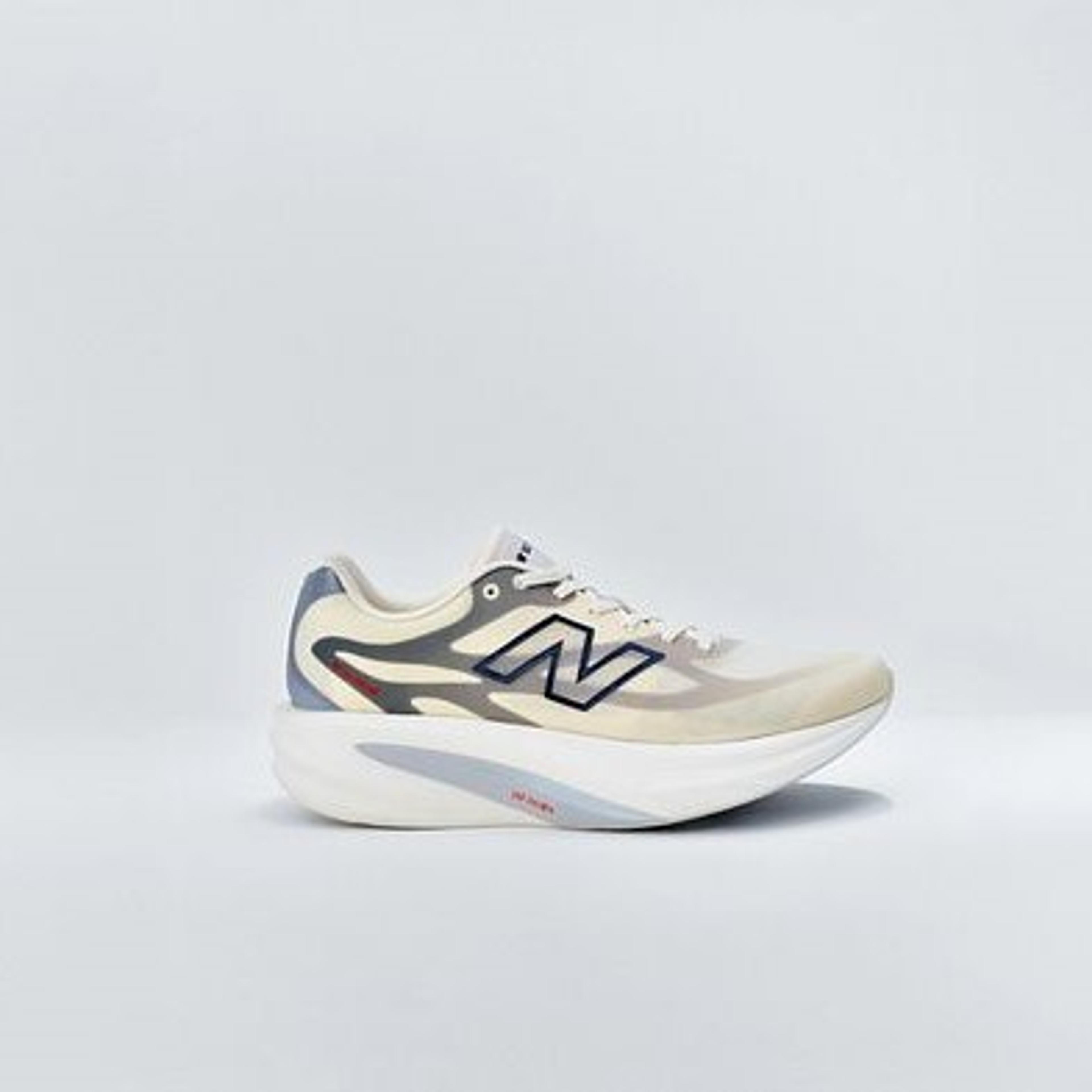 A cream, grey, and blue New Balance running shoe with a thick, curved sole, displayed against a white background.