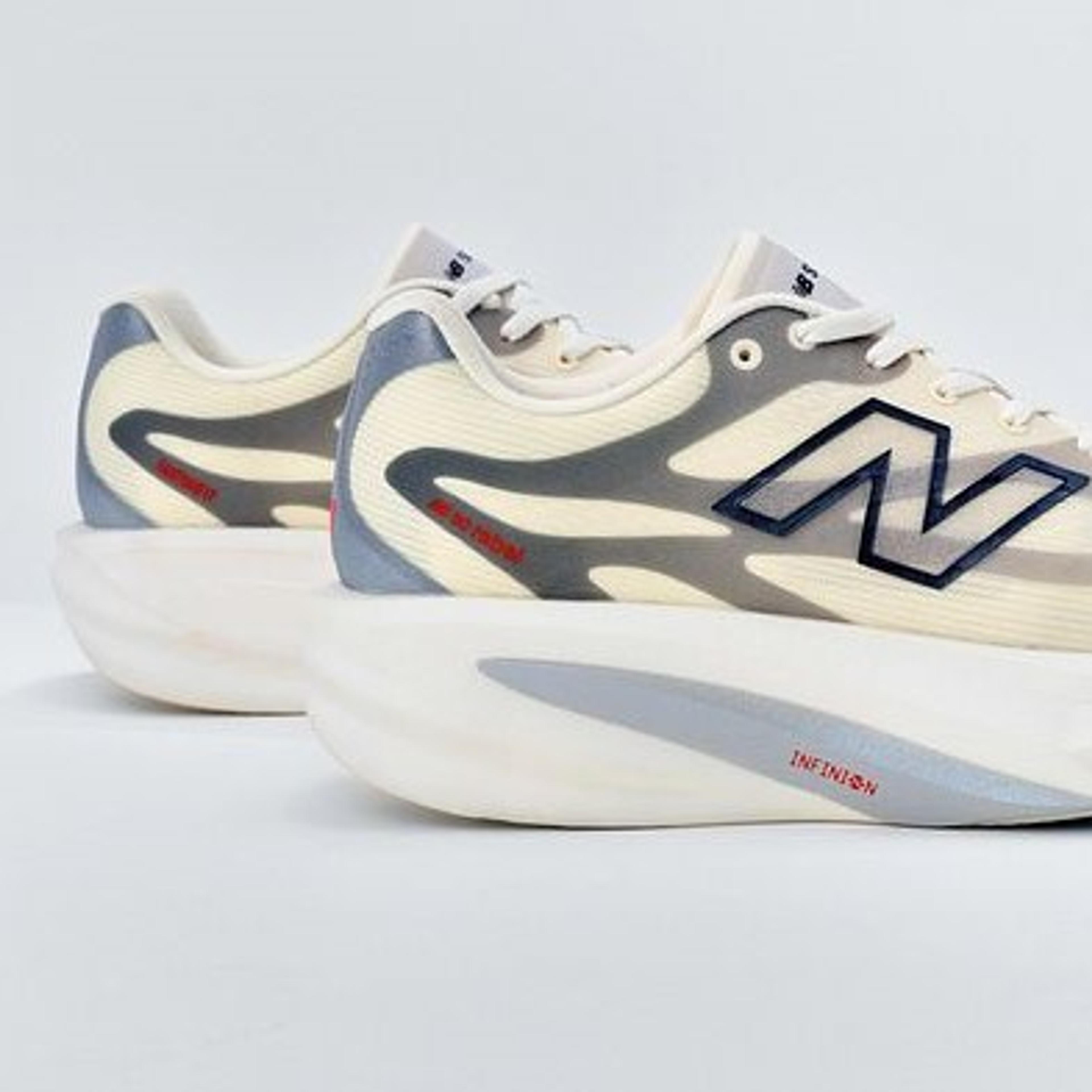 A pair of cream and grey New Balance running shoes with thick sculpted soles and visible 'N' logo and 'INFINION' text.
