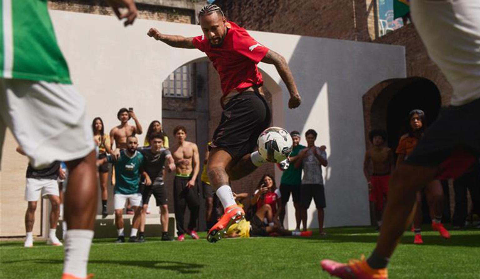 a soccer goalie is diving to catch a soccer ball on a field .