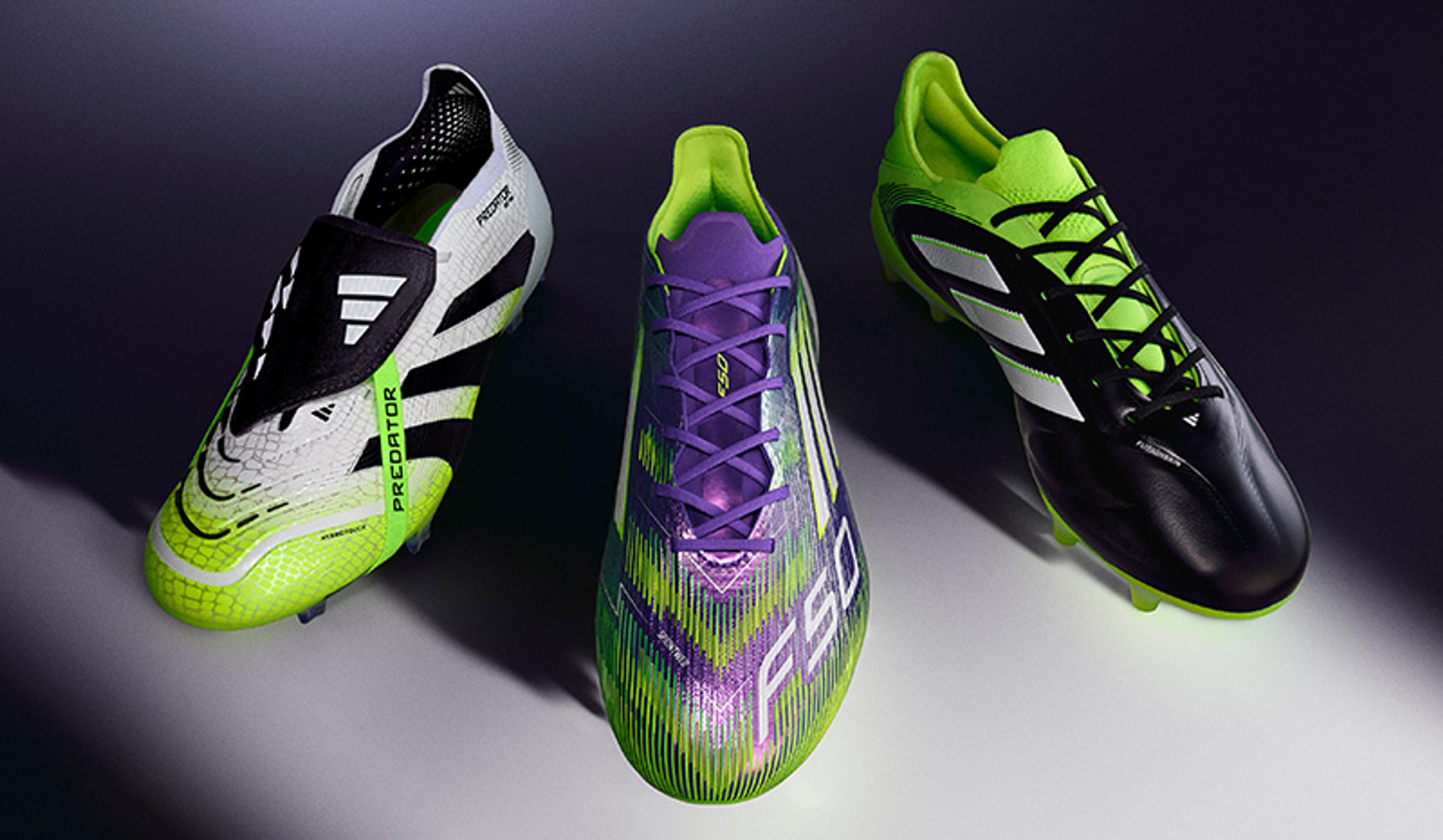 three pairs of soccer cleats are sitting next to each other on a table .