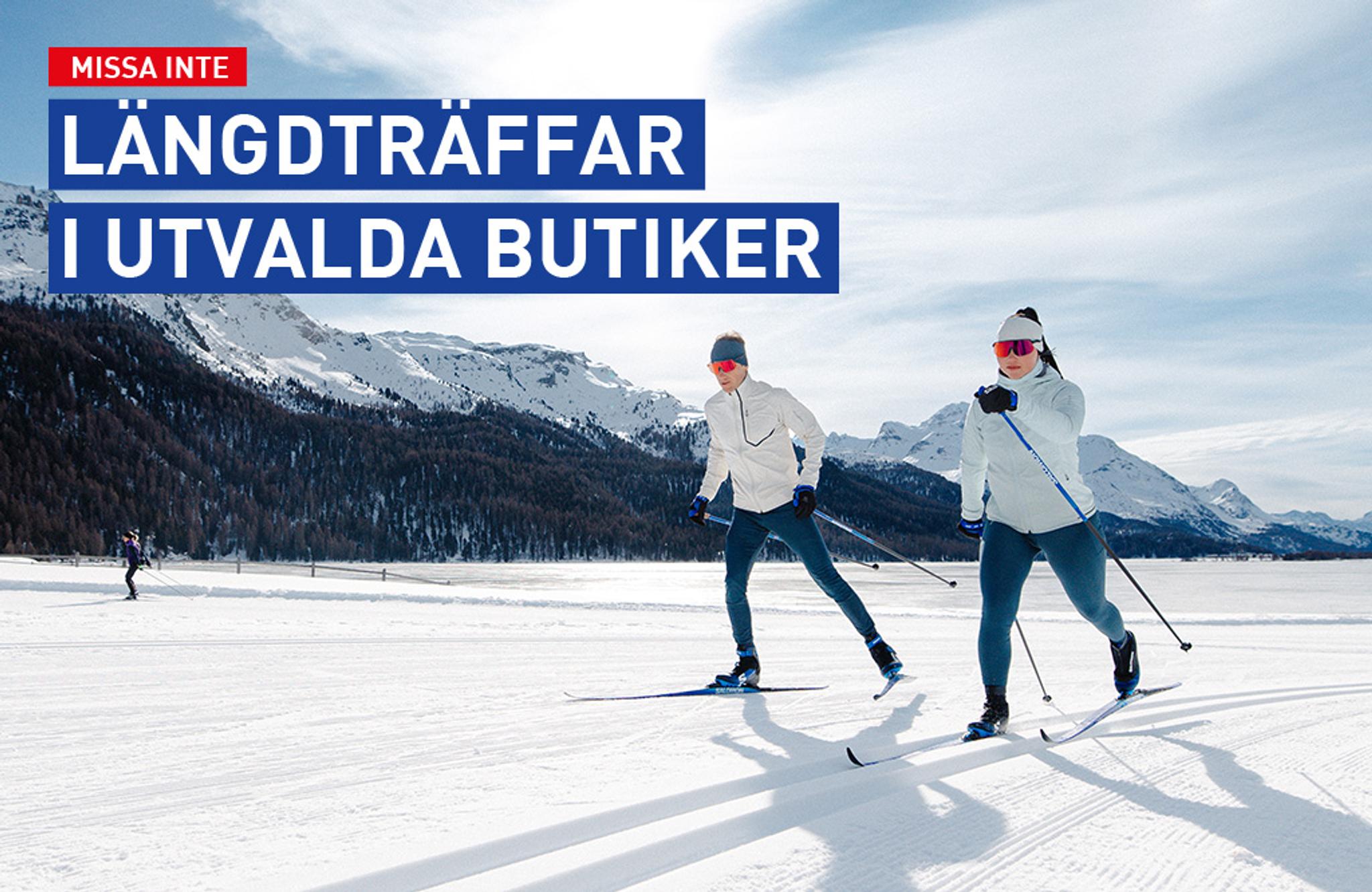 a man and a woman are cross country skiing on a snowy slope .