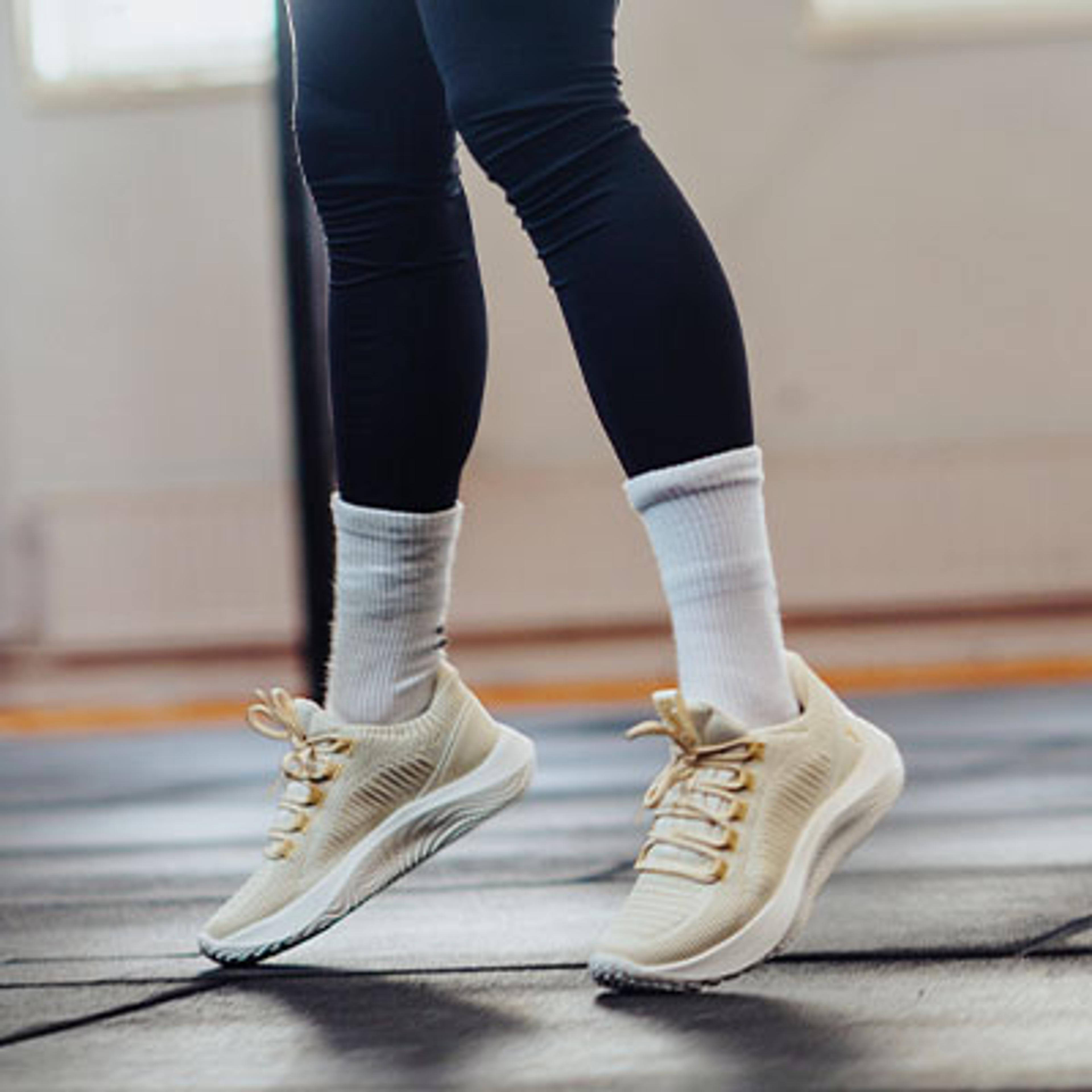 a woman is jumping a jump rope in a gym .