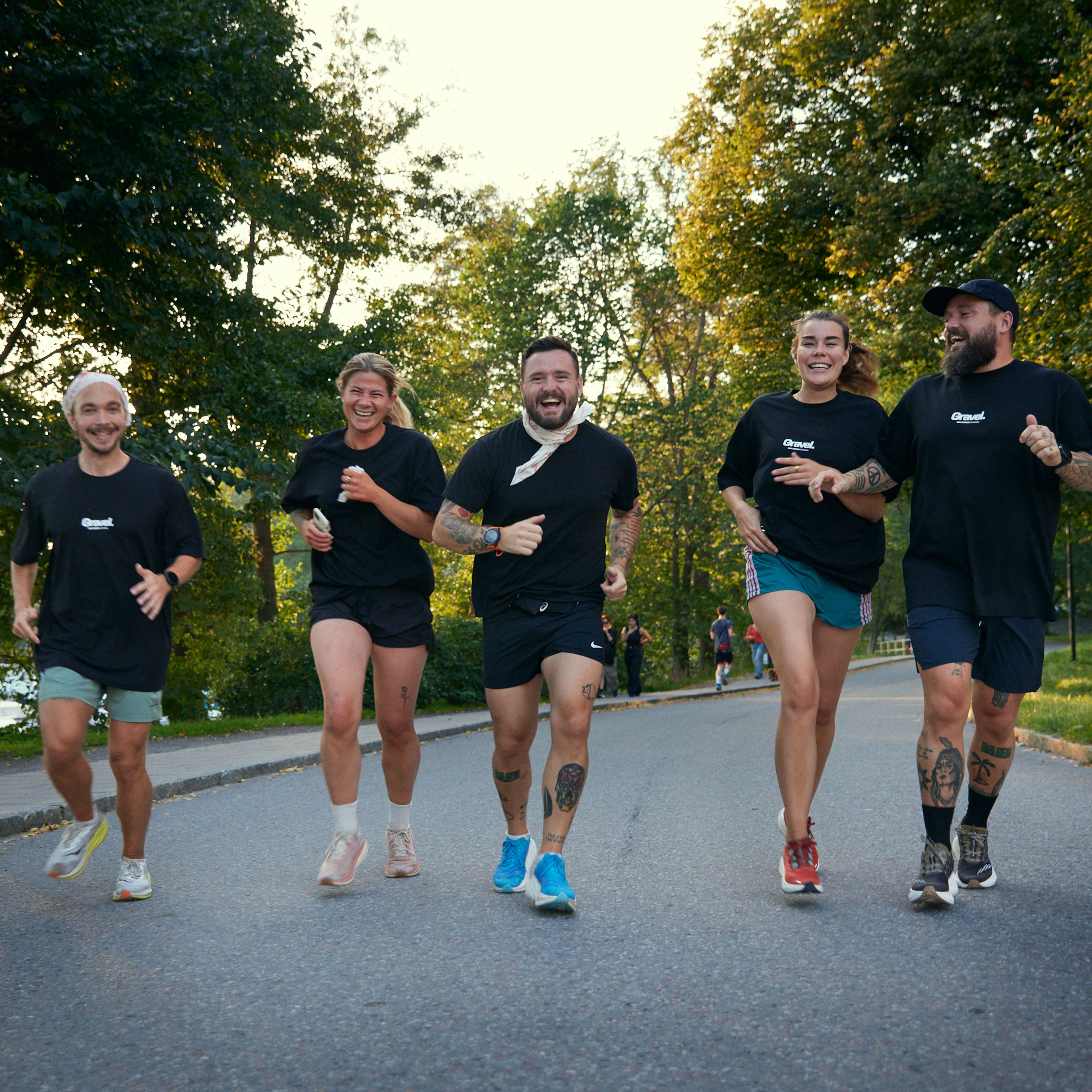 a group of people are running down a street .