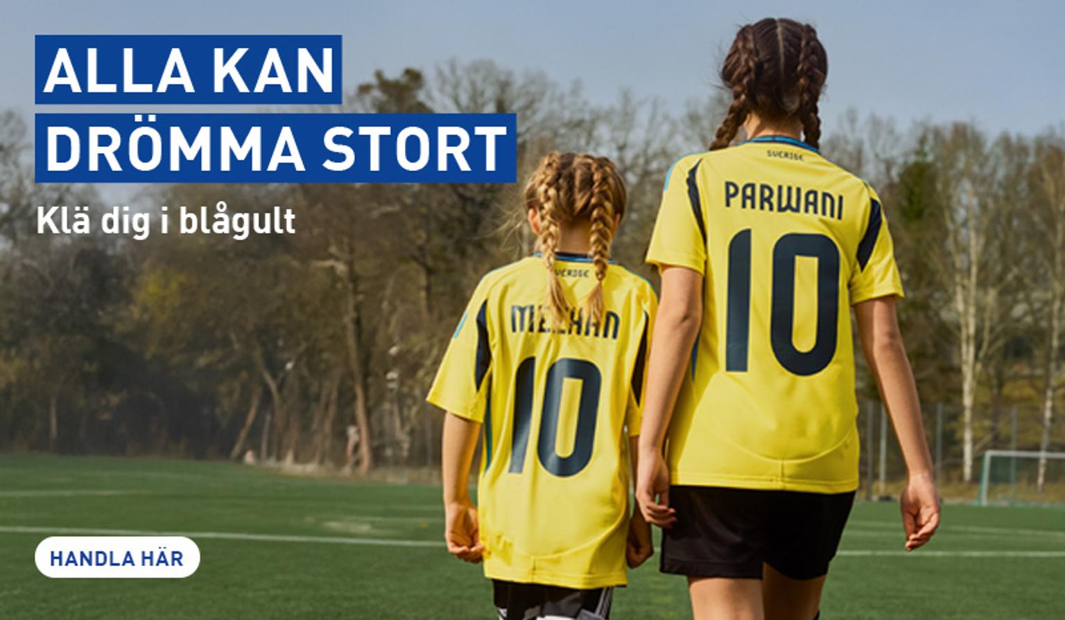 a woman and a child are walking on a soccer field .