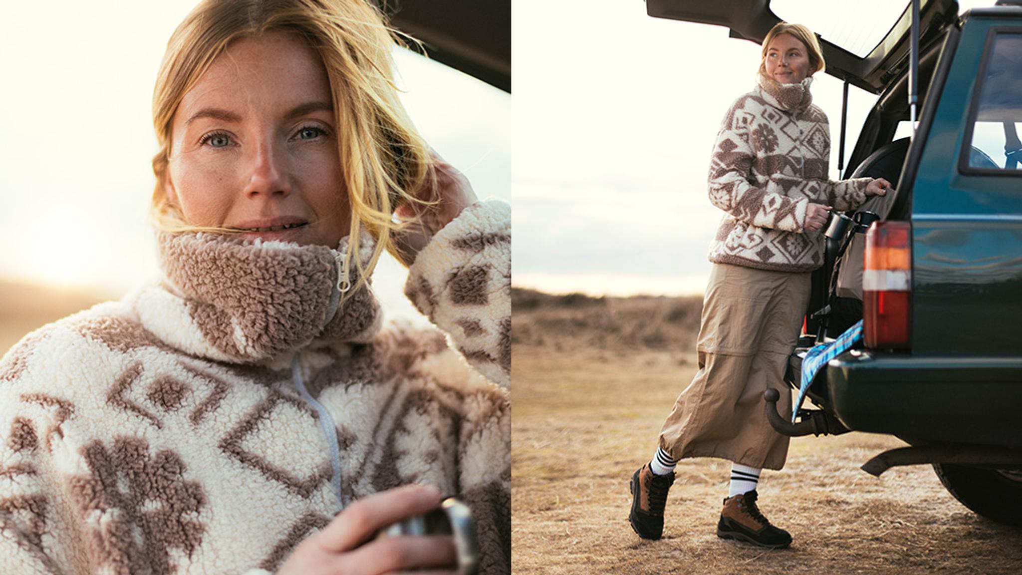 A scenic view of a sunset over a calm lake with silhouettes of trees in the foreground
