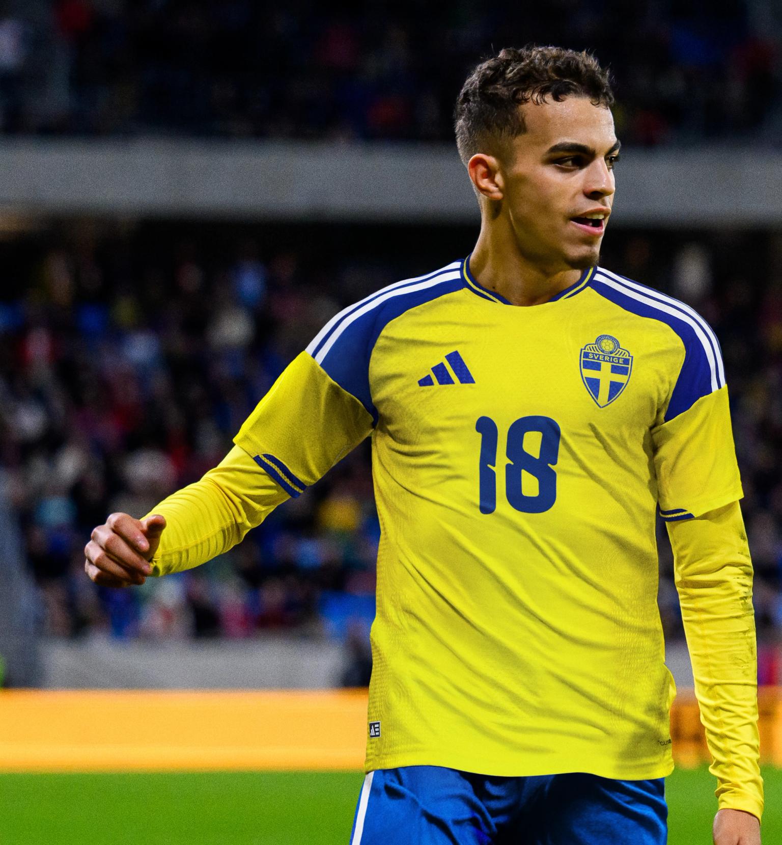 A male soccer player wearing a yellow Sweden jersey with number 18 on a field.