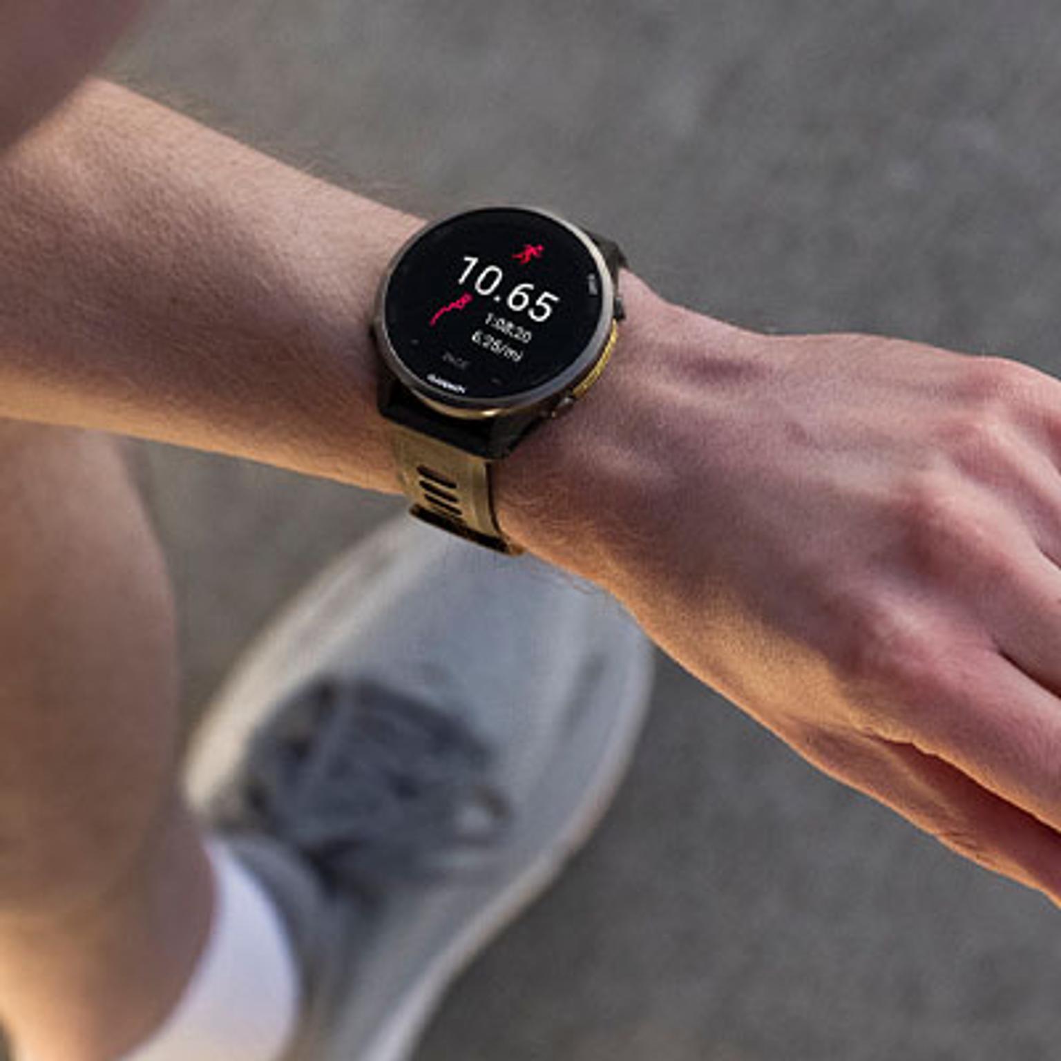 a person is wearing a garmin watch on their wrist .