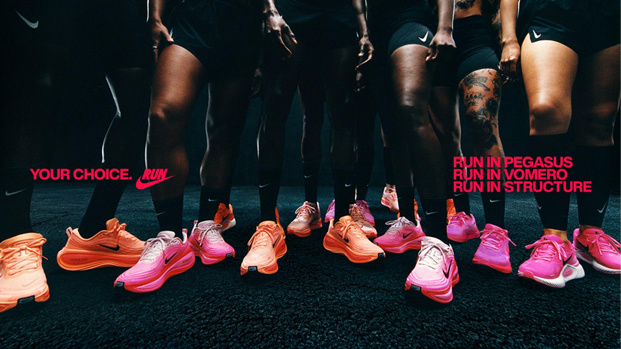 a group of people are standing next to each other wearing pink nike shoes .