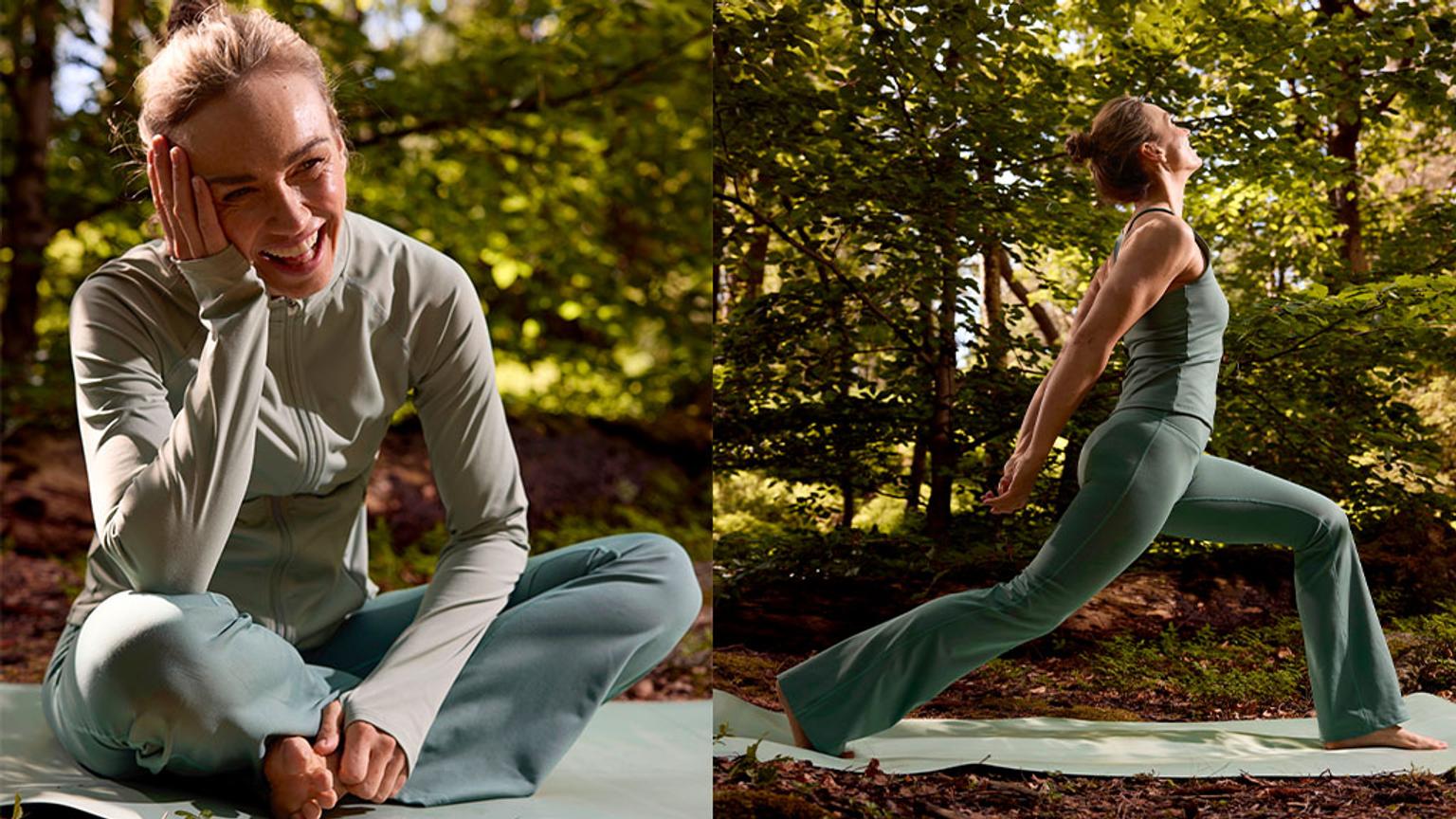 a woman is sitting on a yoga mat in the woods .