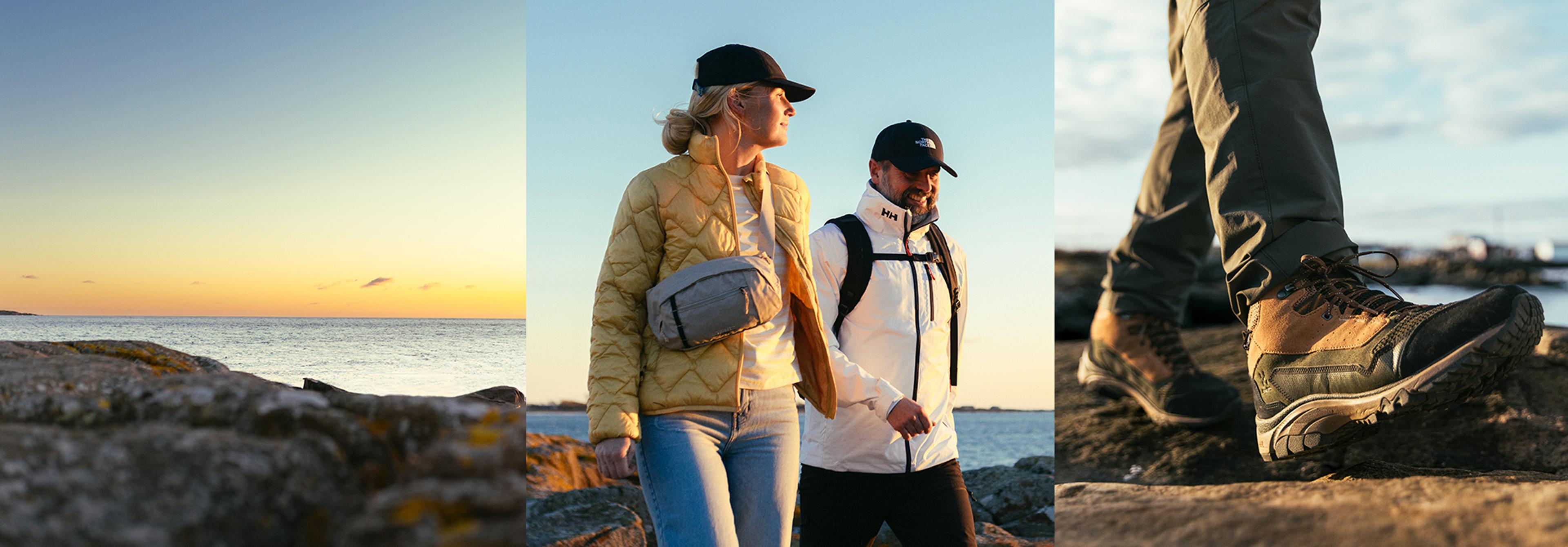 A couple in outdoor gear walks along a rocky coast at sunset, with a close-up on hiking boots traversing the terrain.