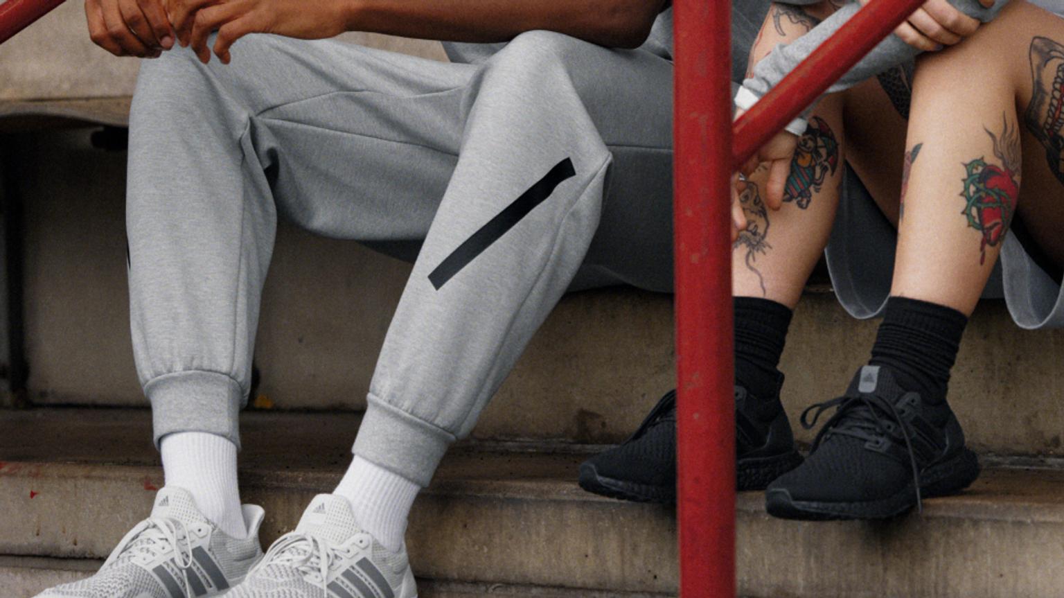 a man and a woman are sitting next to each other on a set of stairs .