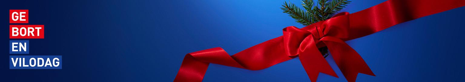 Blue banner with a red ribbon and evergreen sprig, featuring text "GE BORT EN VILODAG".