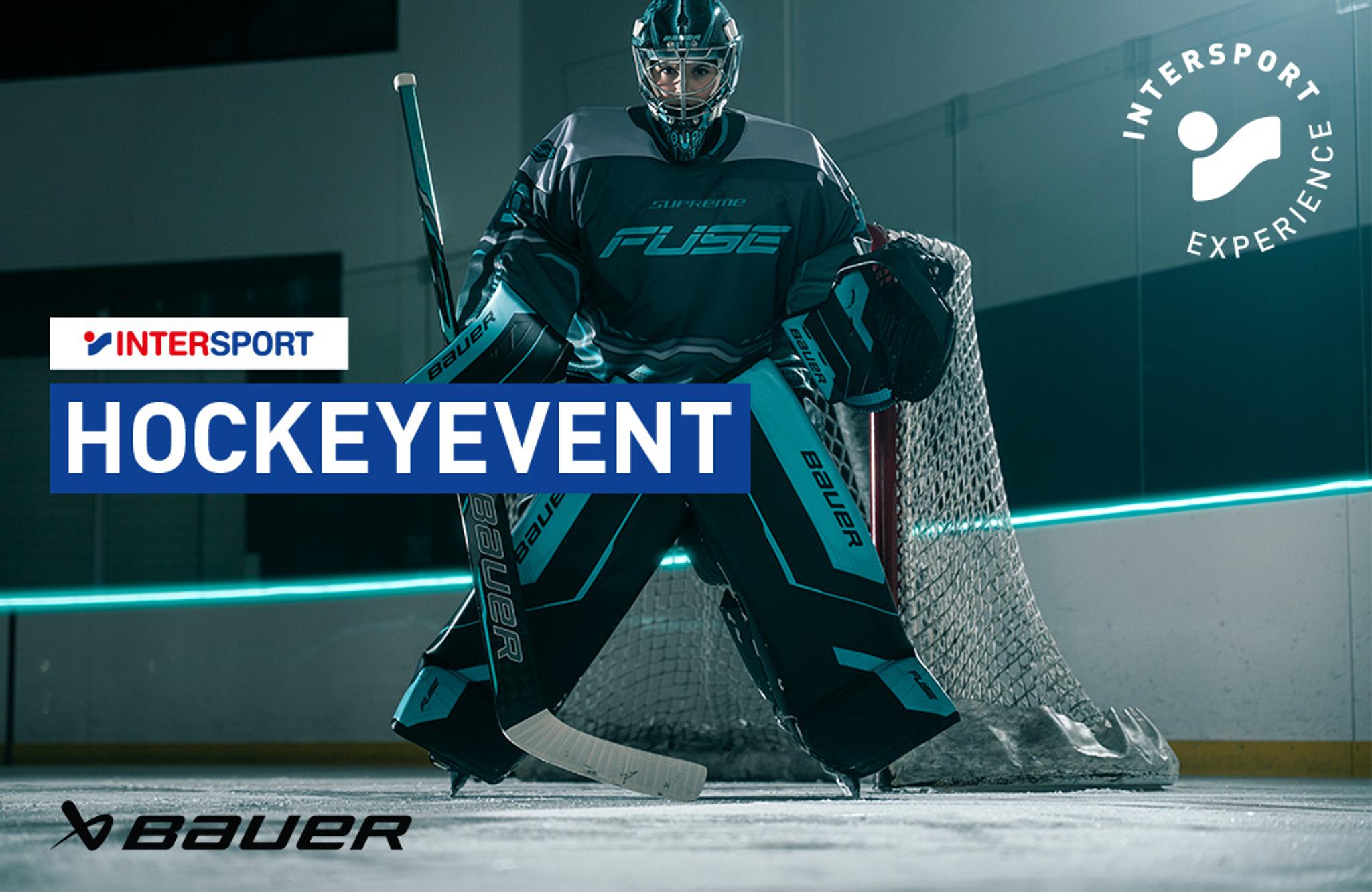 Hockey goalie in gear with "HOCKEYEVENT," "INTERSPORT," "Bauer," and "INTERSPORT EXPERIENCE" logos.