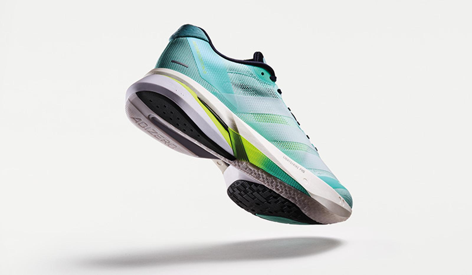 a pair of running shoes is floating in the air on a white background .