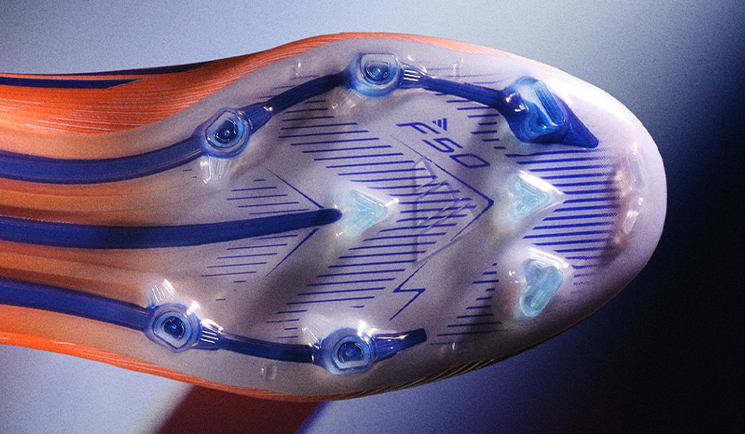 a close up of the bottom of a soccer shoe .