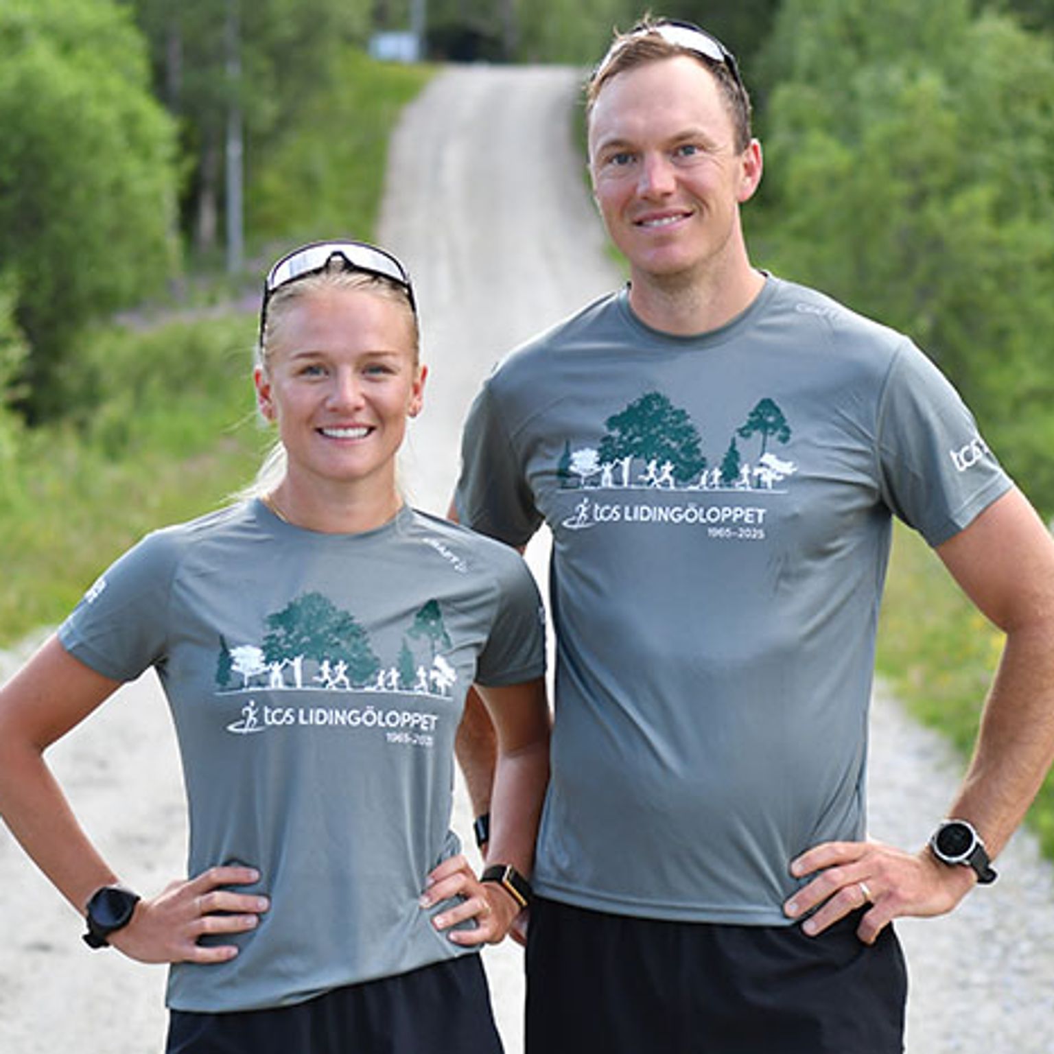 a man and a woman are standing next to each other on a dirt road .