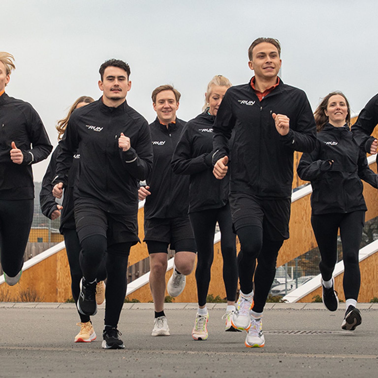 a group of people are running together on a street .