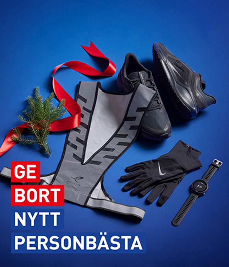 A running gift set featuring black shoes, a reflective vest, gloves, and a GPS watch on a blue background. Text: GE BORT NYTT PERSONBÄSTA.