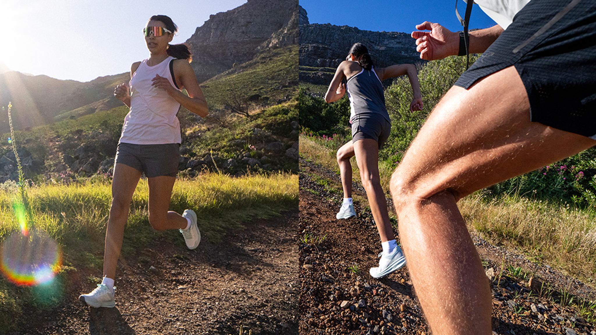 a man is running and jumping over a rock in a forest .