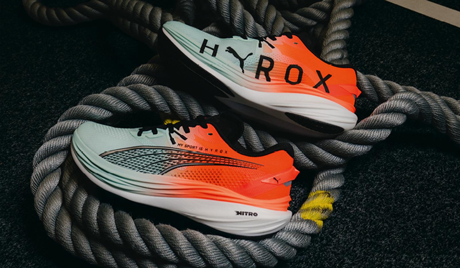 a pair of running shoes sitting on top of a rope .