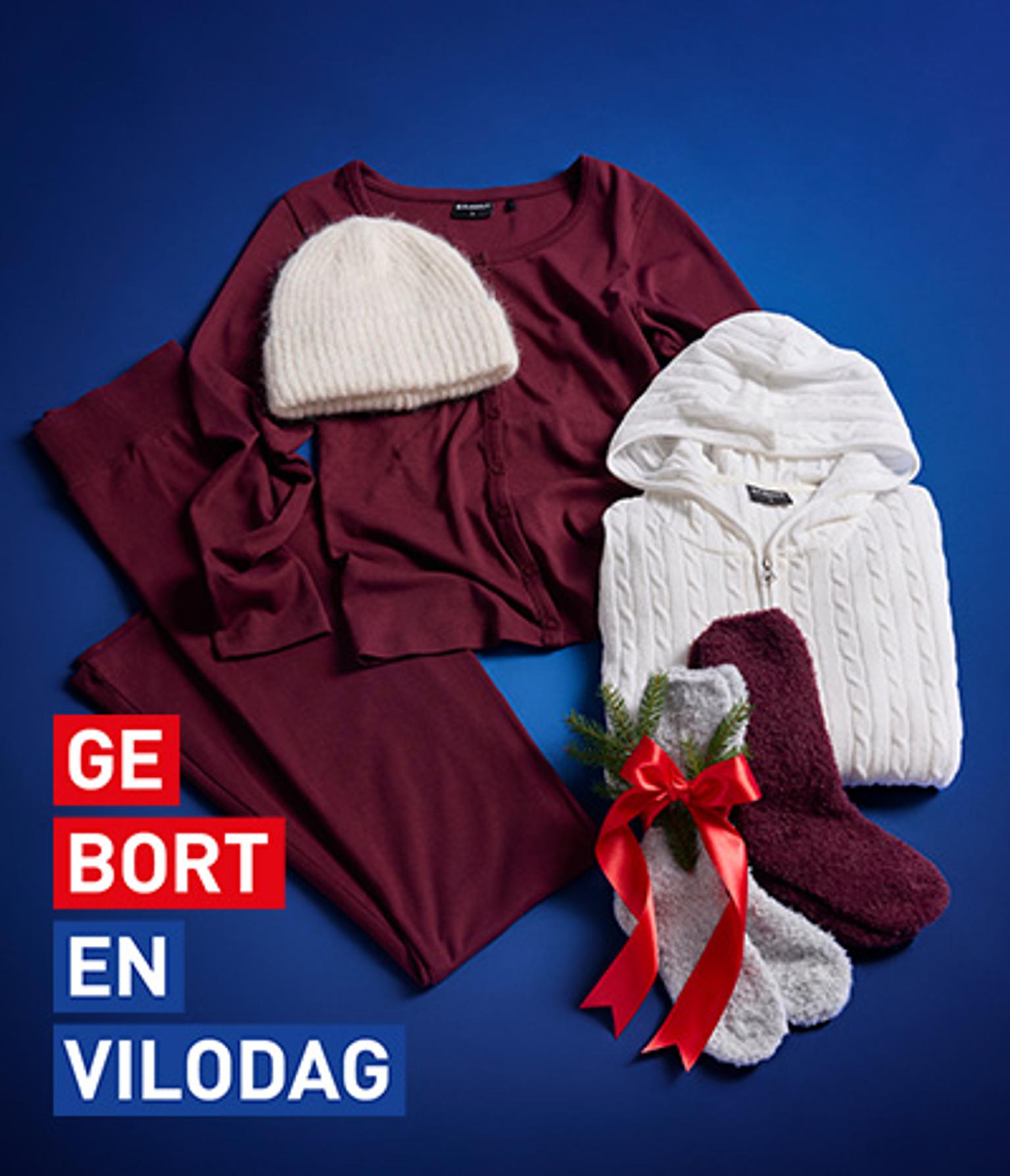 Cozy winter clothing: maroon top and pants, cream beanie, white cable-knit hoodie, and fuzzy socks with a red bow. Text: GEBORT EN VILODAG.