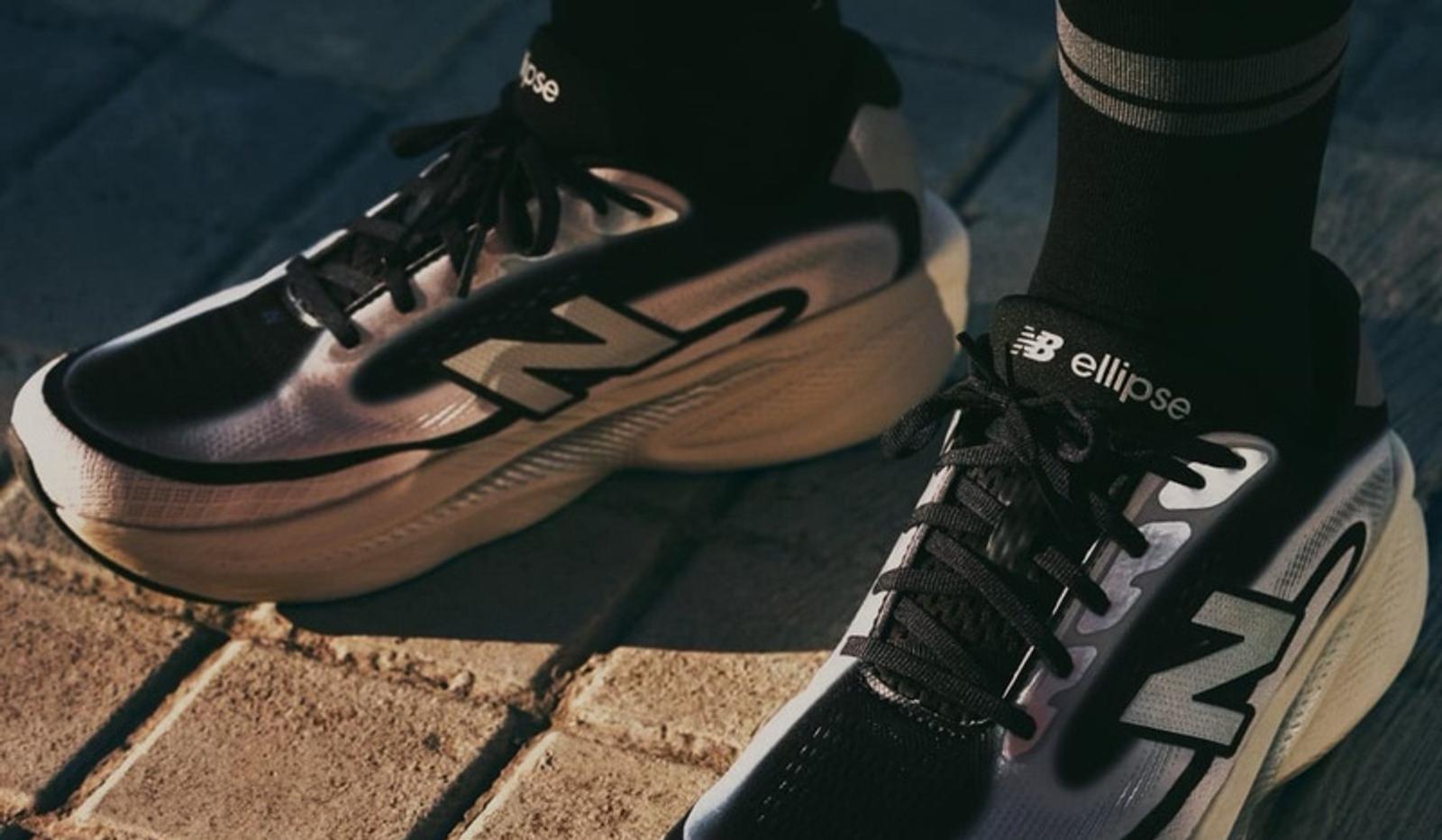 Close-up of black and silver New Balance running shoes worn with black socks on a brick surface.