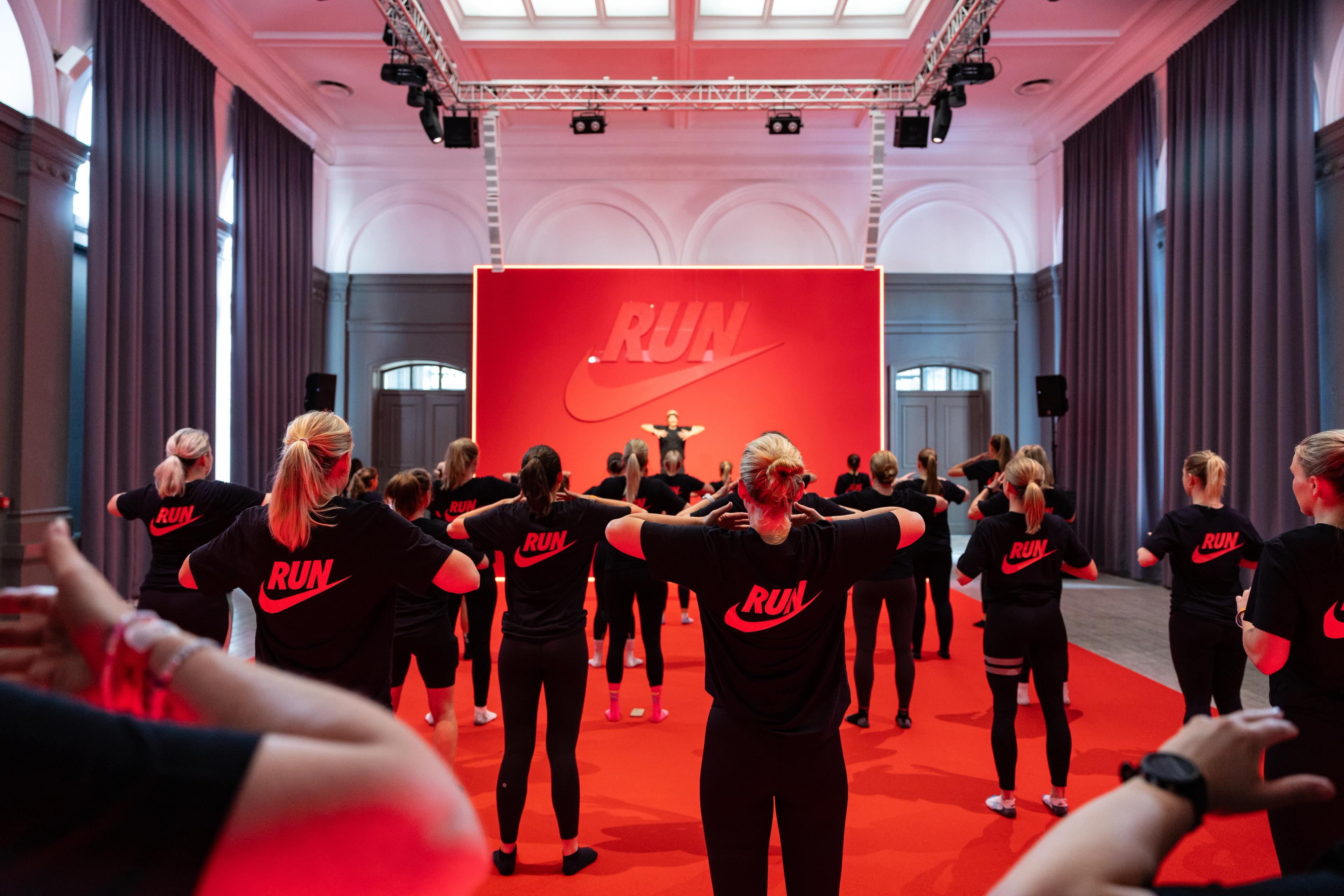 a group of people are doing exercises in a large room .