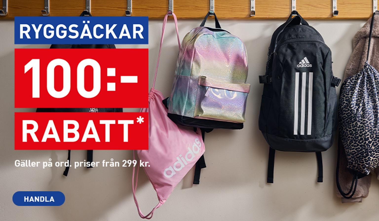 a bunch of backpacks are hanging on a rack .