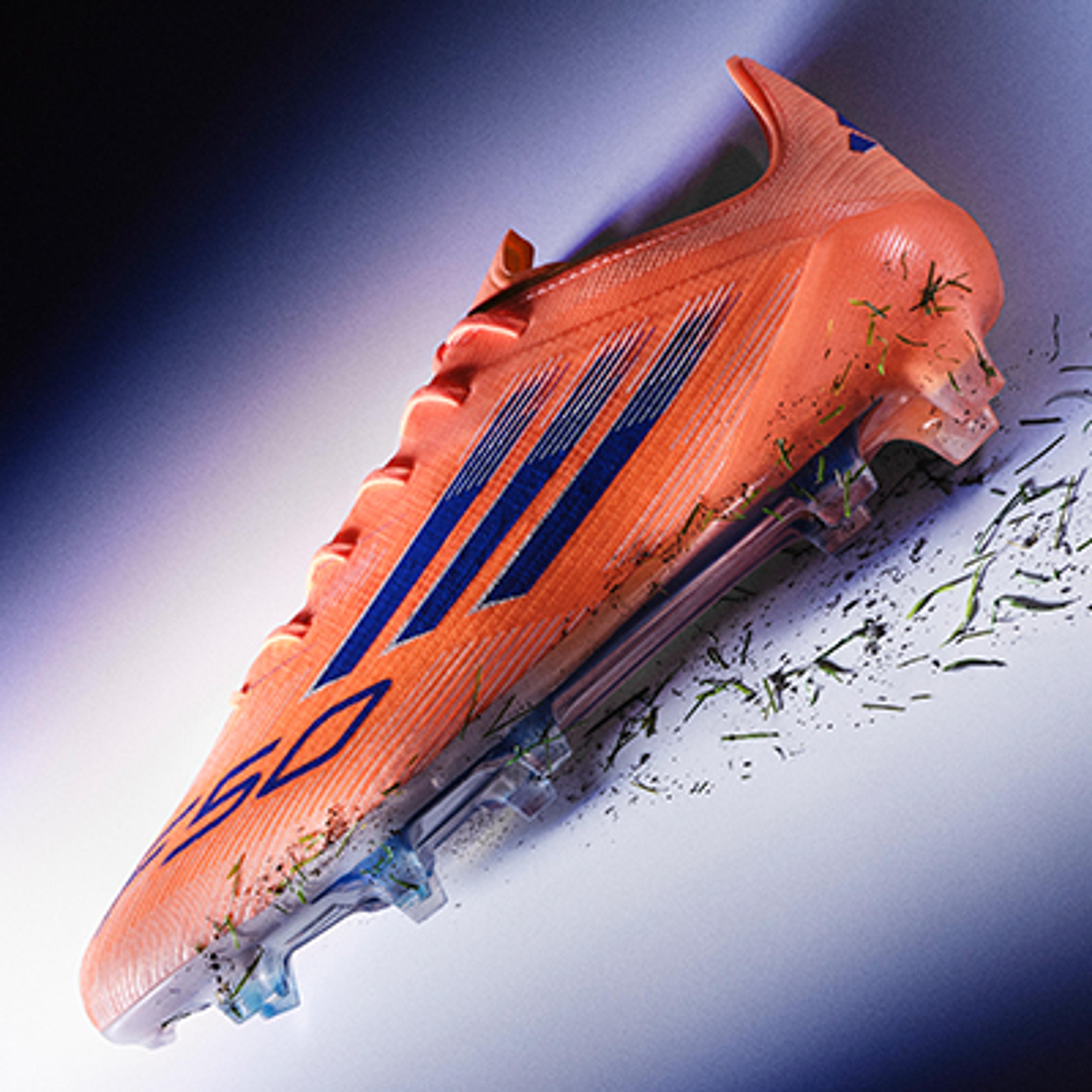 a close up of a soccer shoe on a white surface .