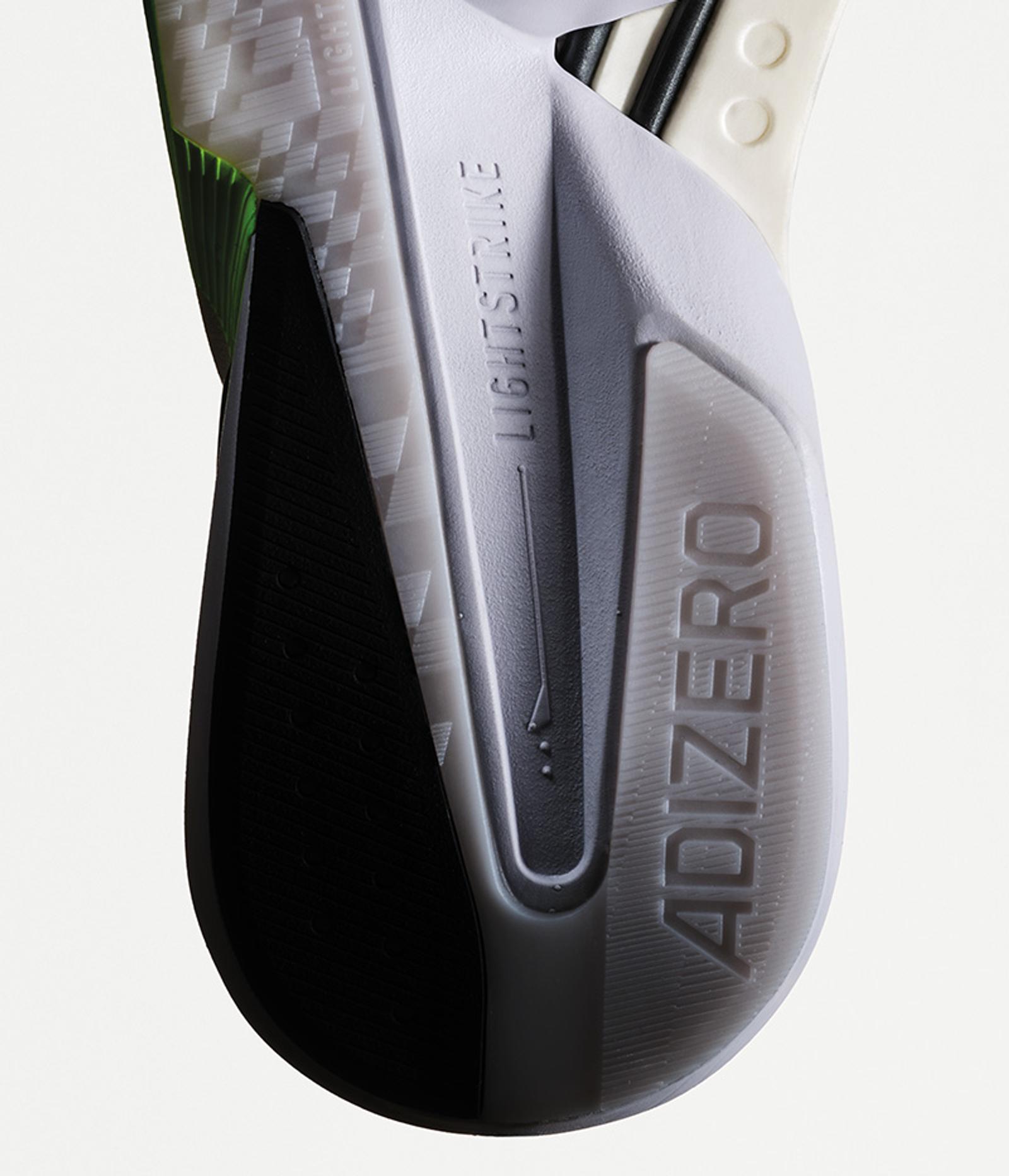 a close up of the bottom of a shoe that says adizero