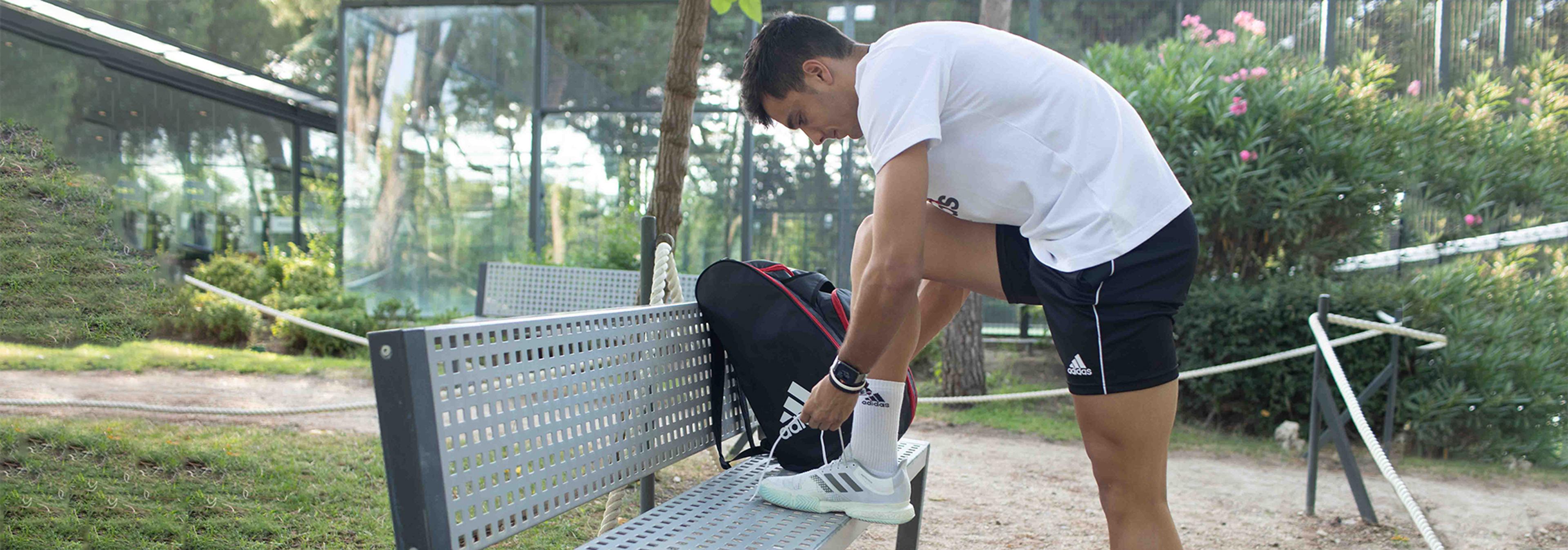 En person knyter sina padelskor