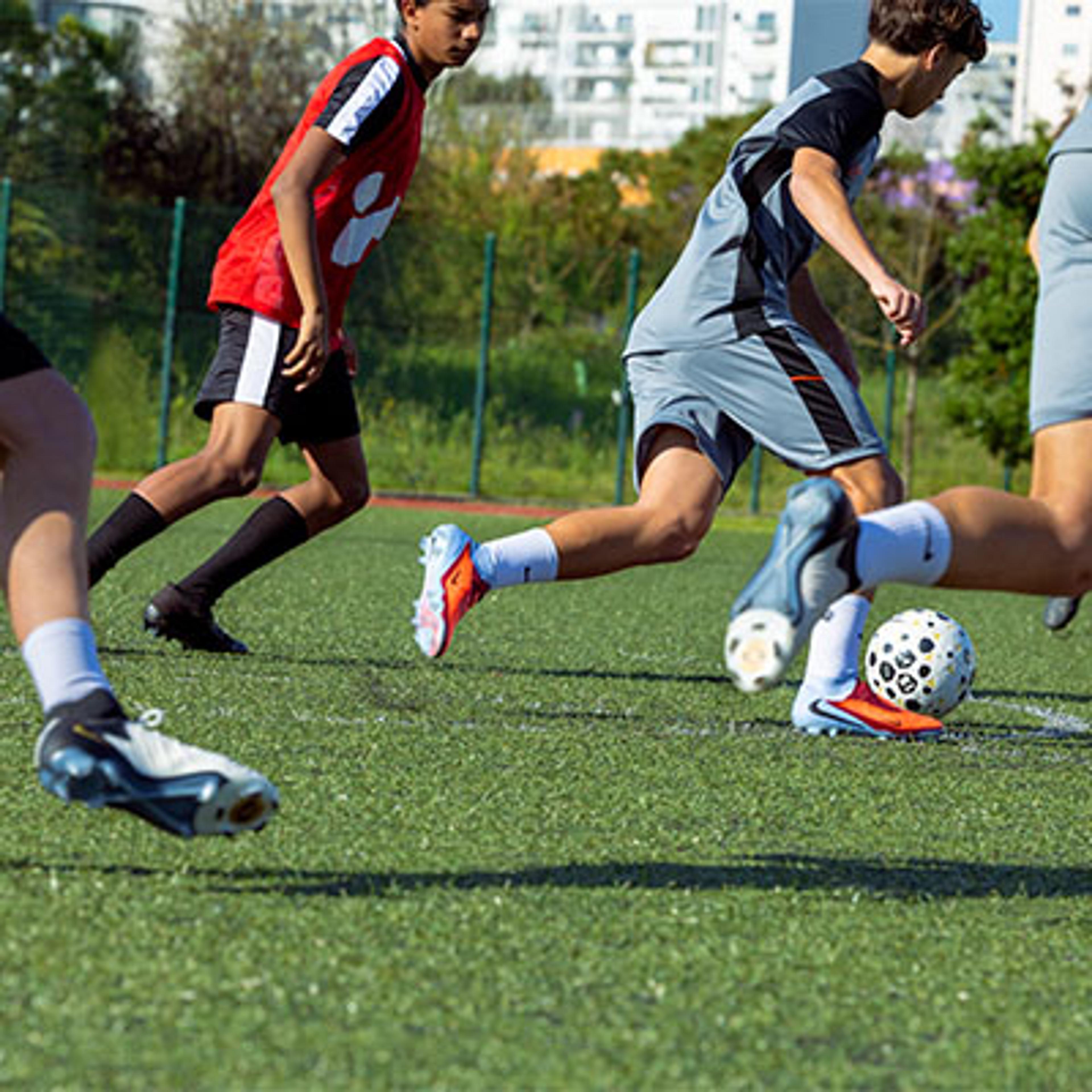 a group of young men are playing soccer on a field .
