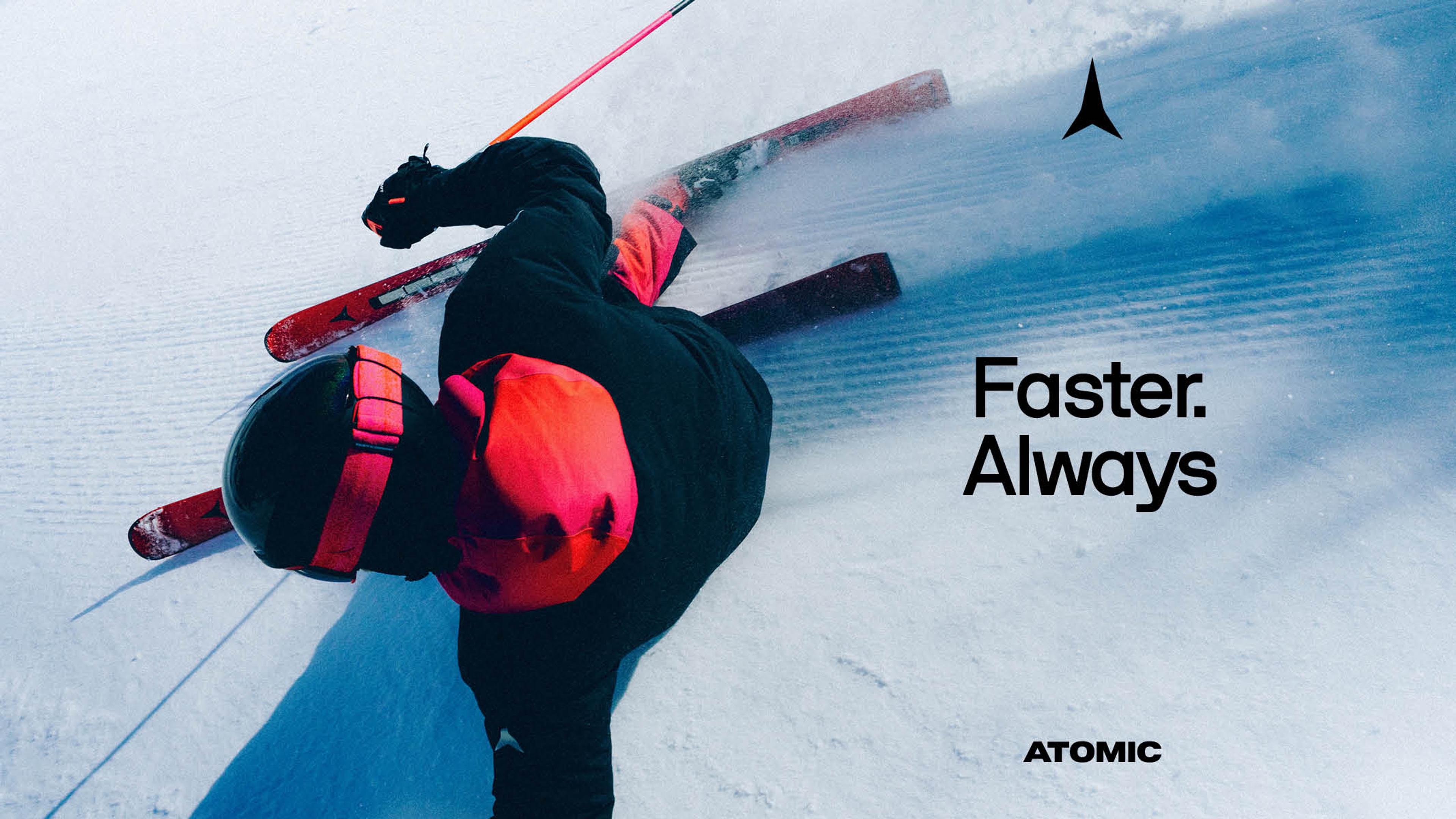 Overhead view of a person skiing on red skis, kicking up snow. Text reads "Faster. Always." and "ATOMIC."