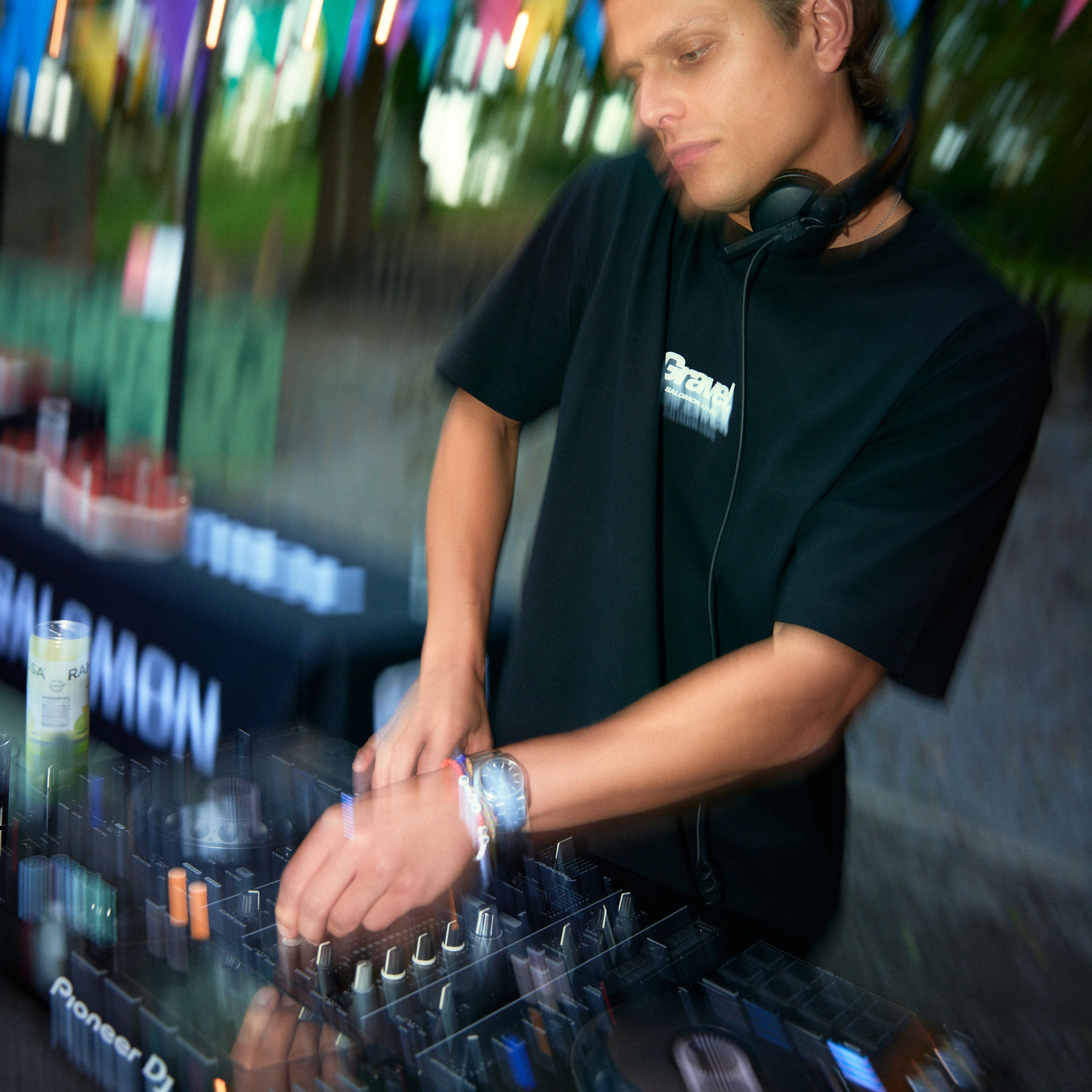 a man wearing headphones is playing music on a pioneer dj mixer