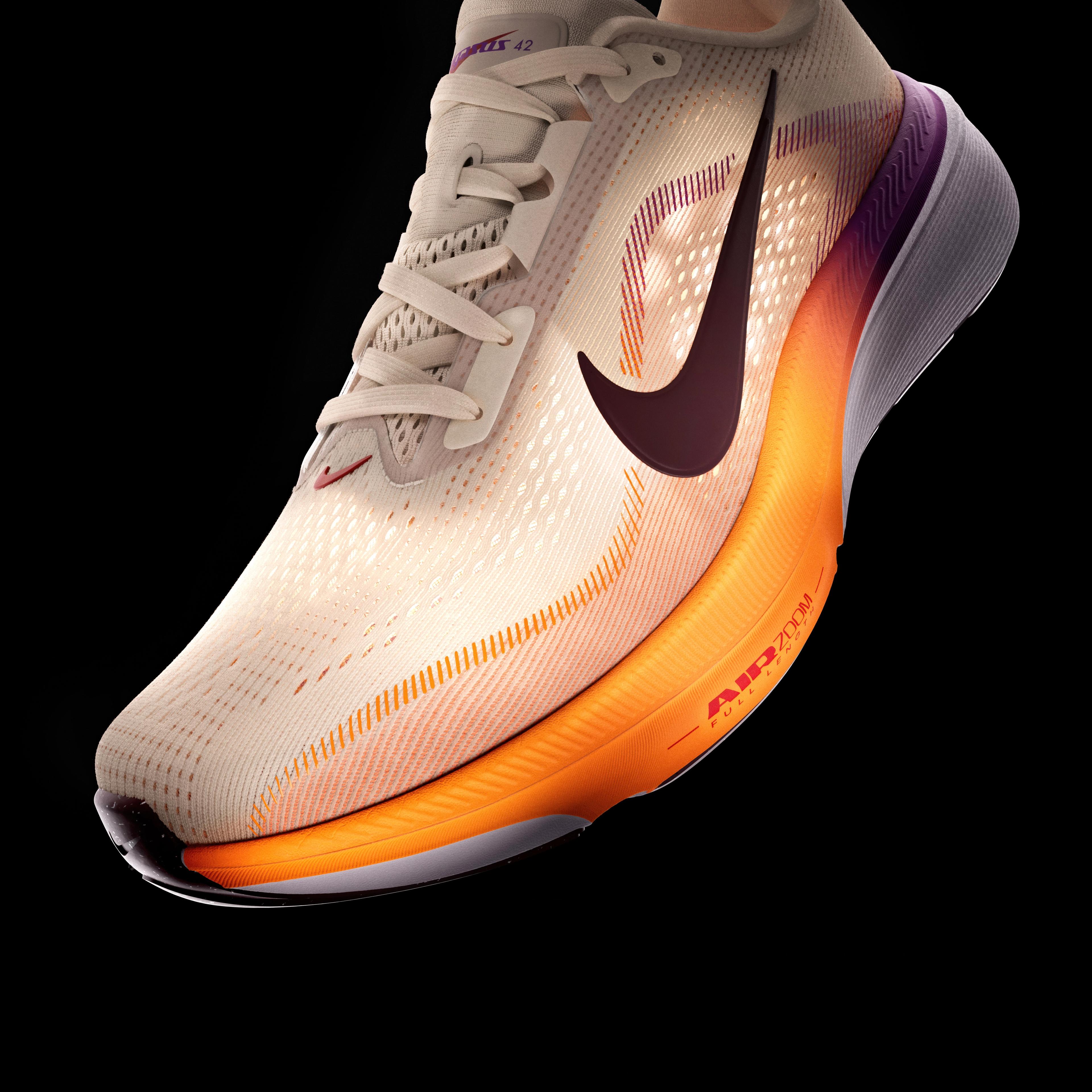 A light beige Nike running shoe with a dark maroon swoosh and an orange-purple gradient midsole on a black background.