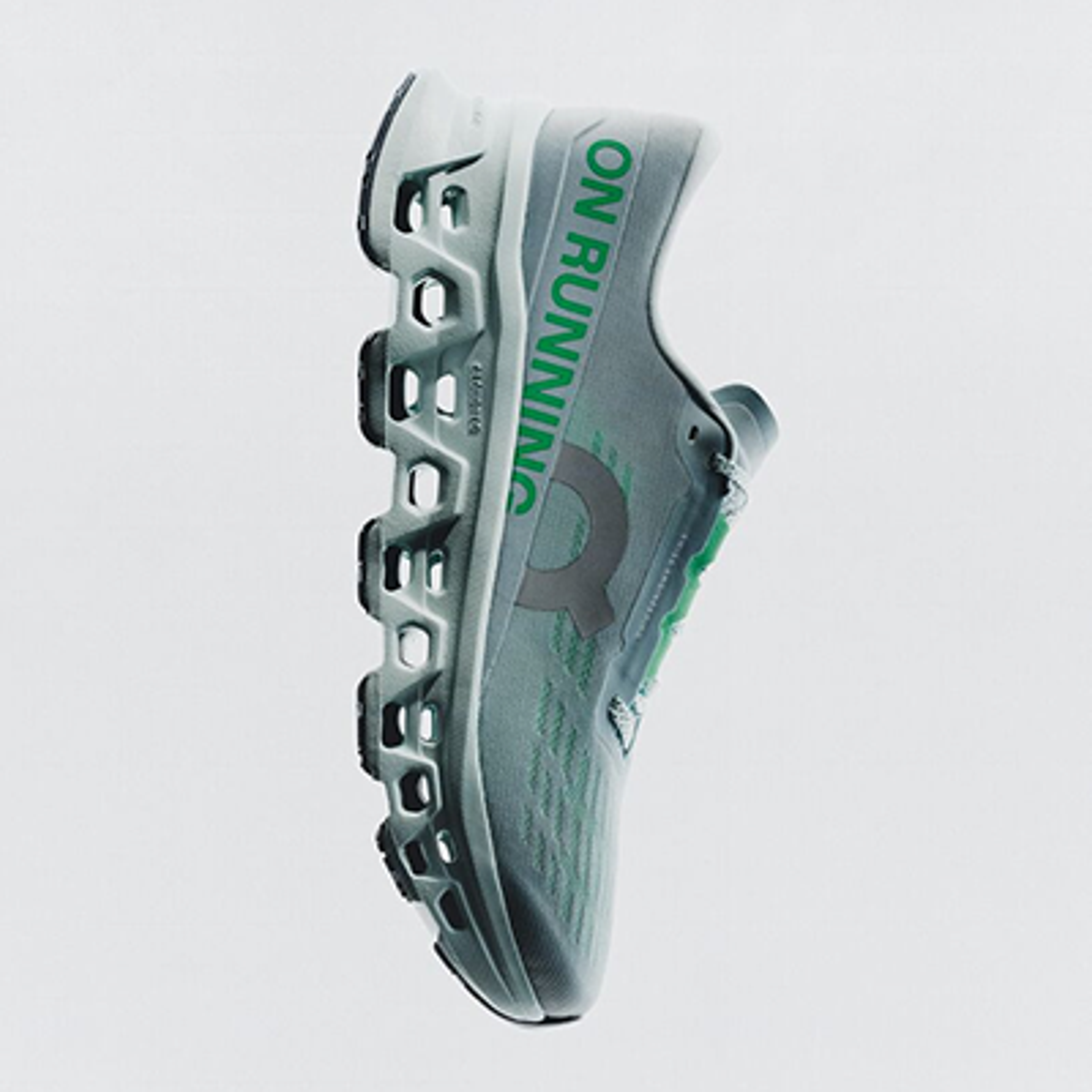 Light grey On Running shoe with green text, oriented vertically.