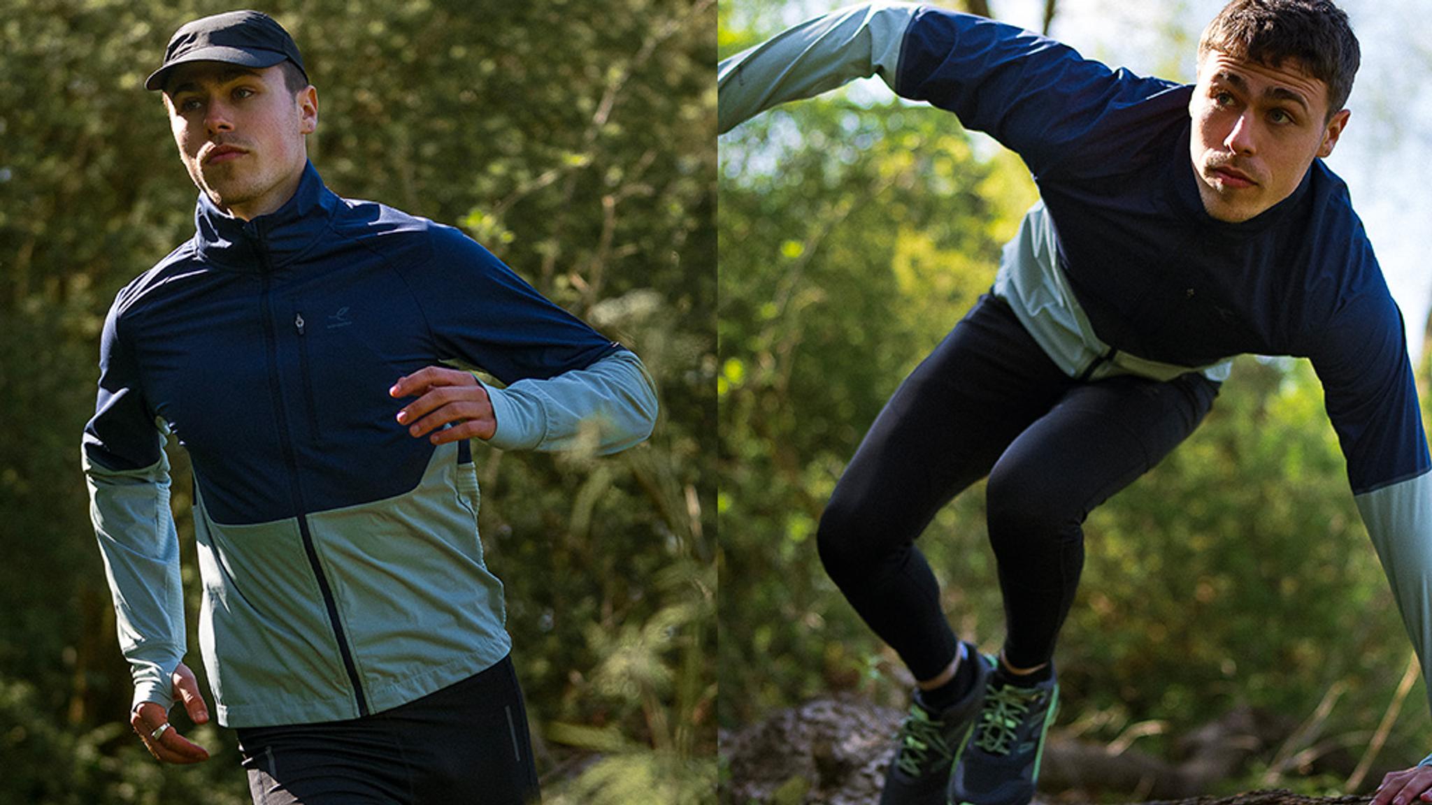 a man is running and jumping over a rock in a forest .