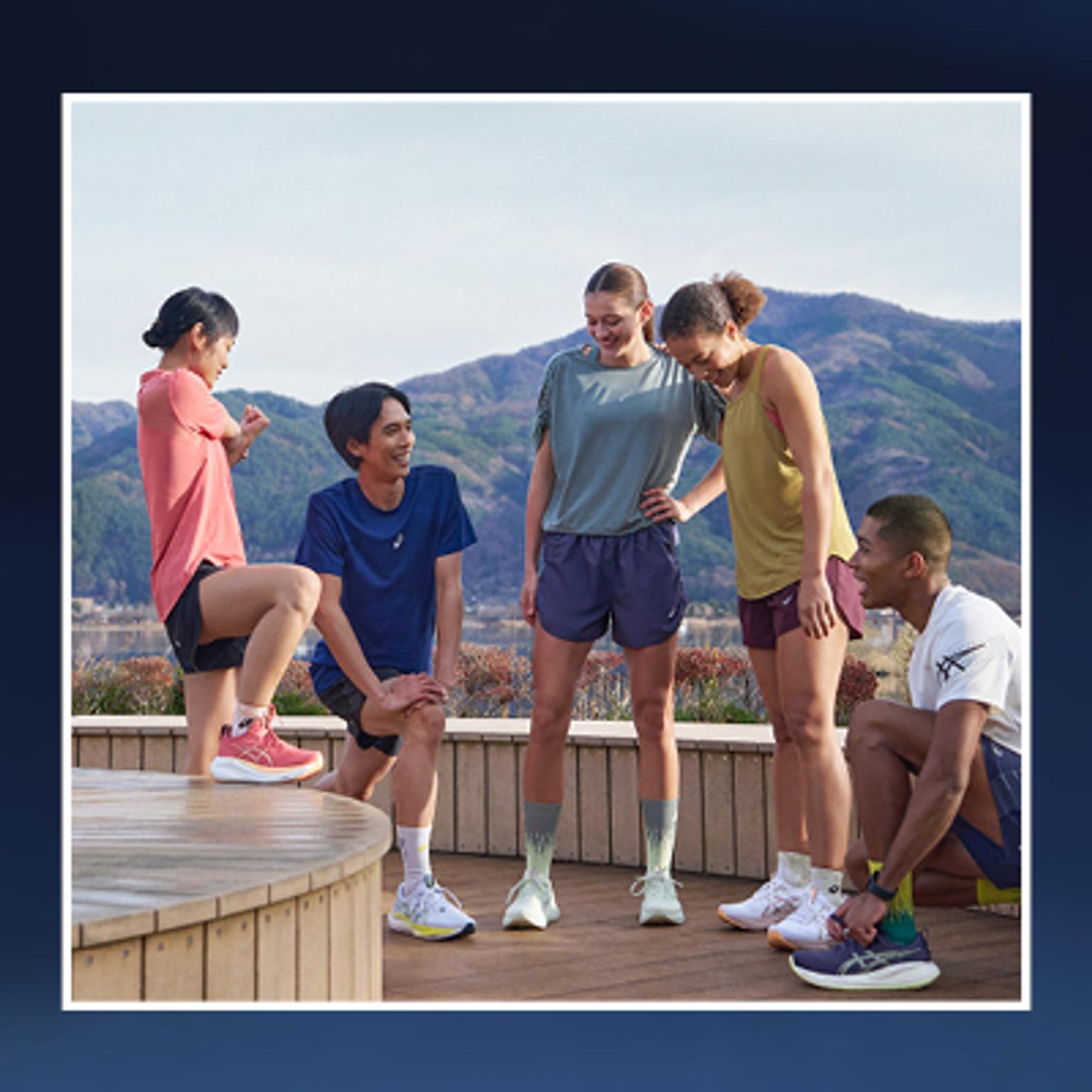 a group of people are standing next to each other on a wooden deck .