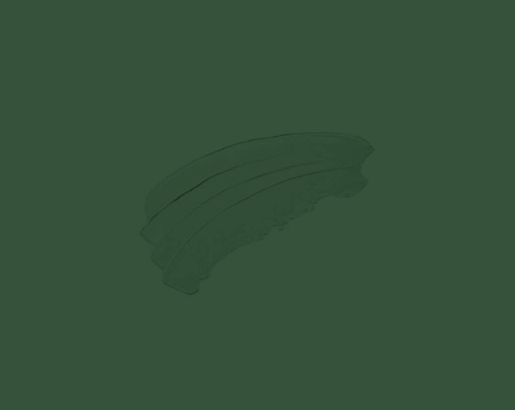 A set of three stacked banana slices is placed on a plain, solid green background.