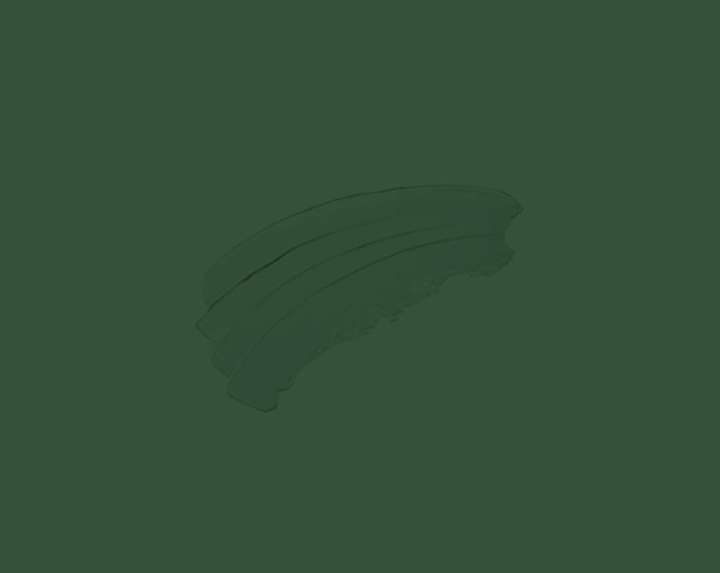 A set of three stacked banana slices is placed on a plain, solid green background.