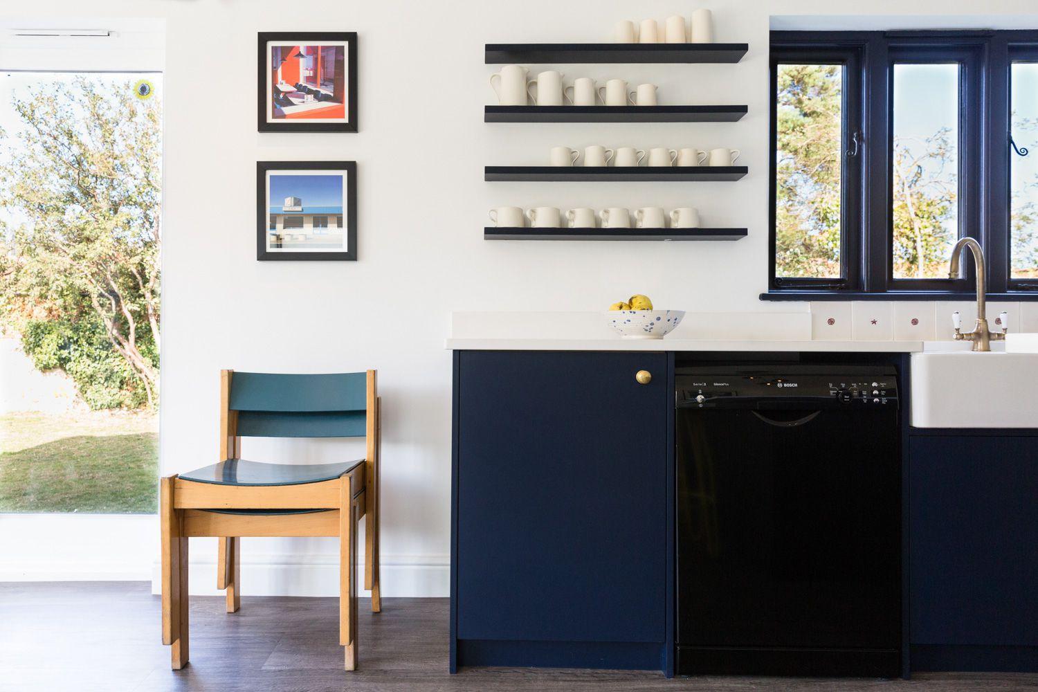 Open shelving showcases frequently used cookware, adding a touch of individuality & personalization to the sleek space.