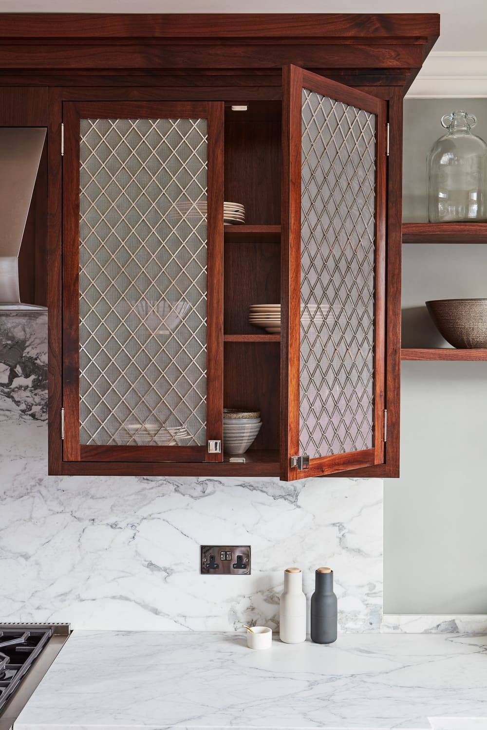 A detailed view of the Georgian Hall kitchen's cabinets reveals the intricate grain of the walnut wood, adding depth and character to the overall design.