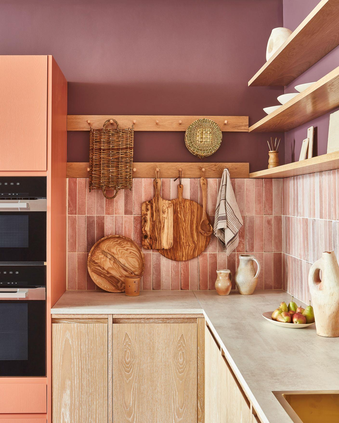 A detailed view of the kitchen's exquisite cabinetry, featuring a harmonious blend of soft purple and pink hues. The cabinets' subtle graining and elegant brass handles add a touch of refinement to the space.