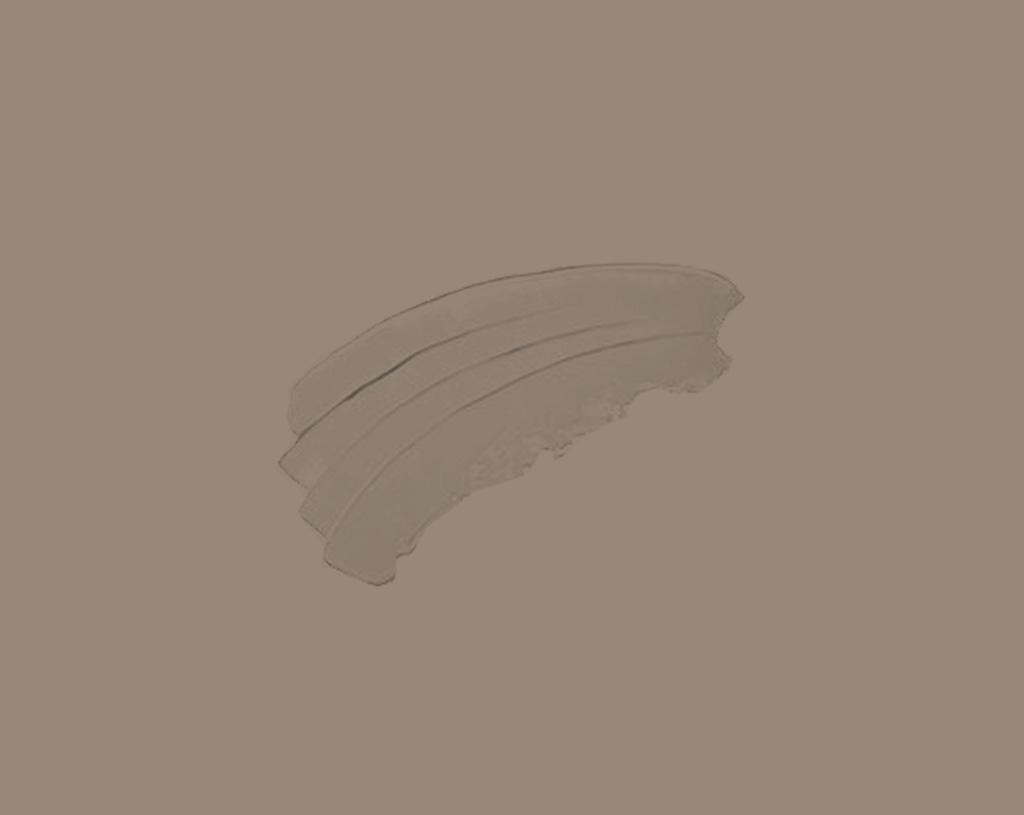 Three slices of turkey deli meat are stacked on a plain, light beige background.
